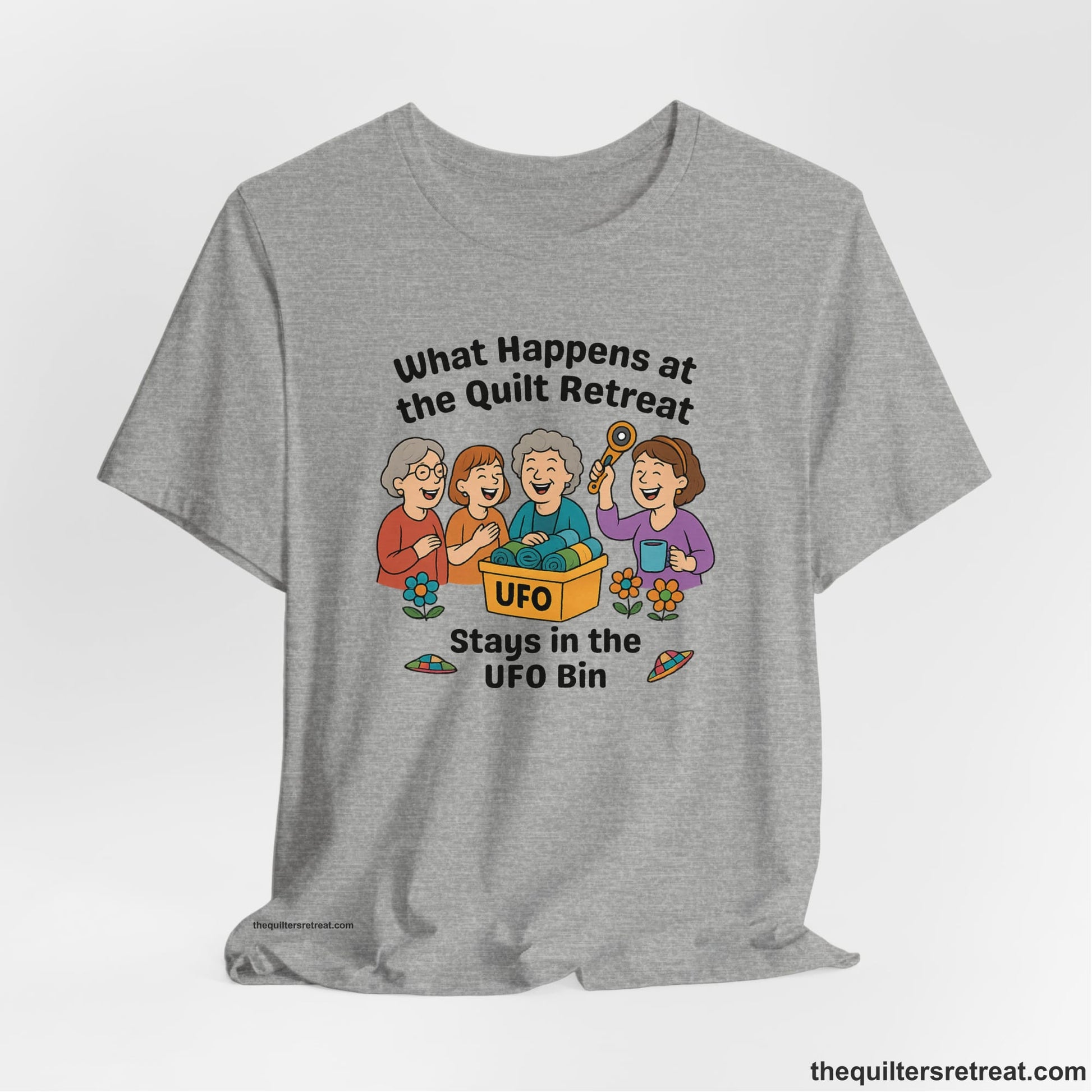 A Athletic Heather Short Sleeve T-Shirt with a four smiling women with unfinished fabric objects and playful "UFO" text in a cartoon style