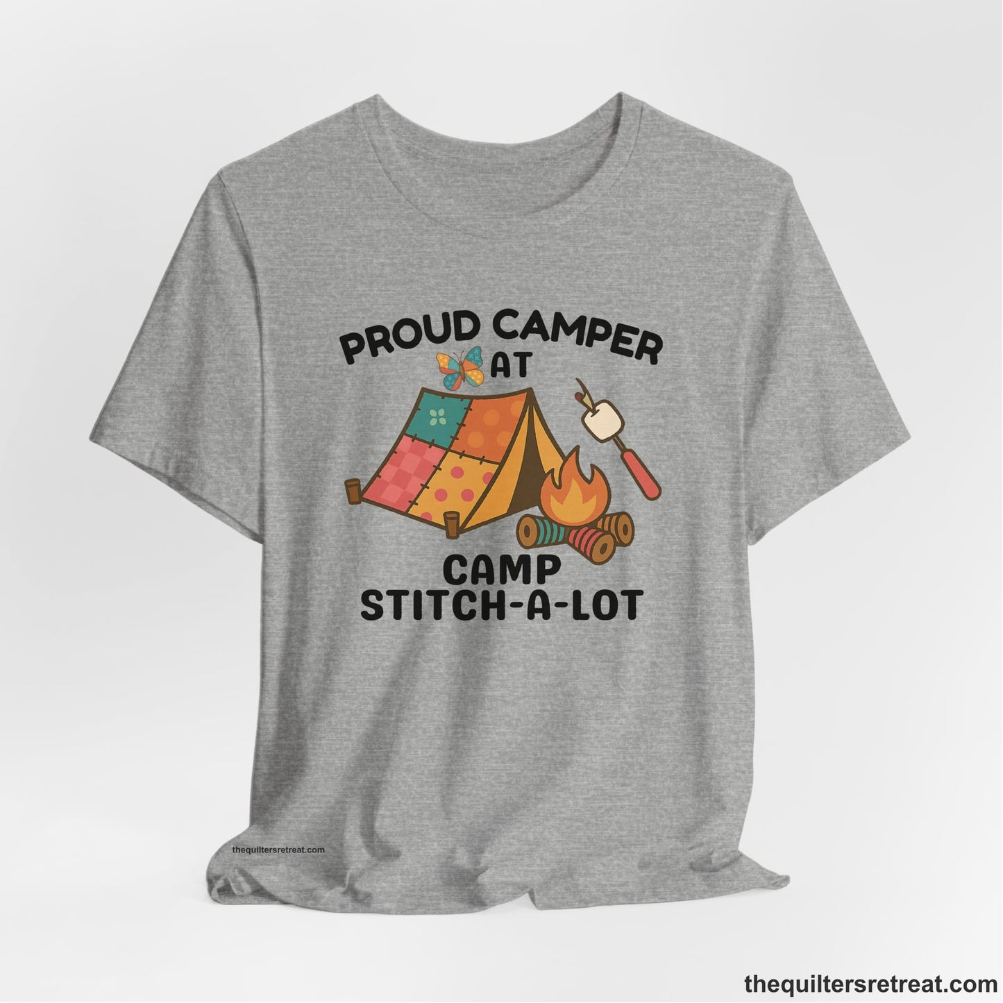 A Athletic Heather Short Sleeve T-Shirt with a camping scene with patchwork tent, campfire, and whimsical butterfly and marshmallow illustration