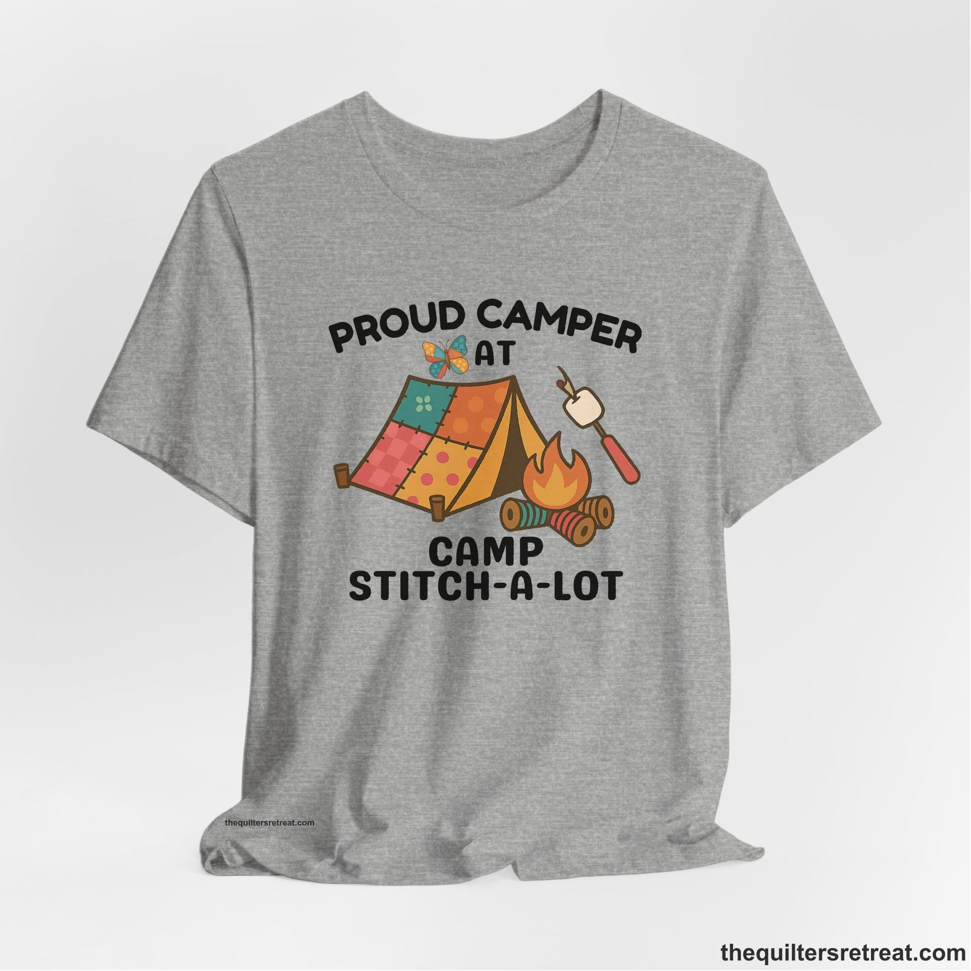 A Athletic Heather Short Sleeve T-Shirt with a camping scene with patchwork tent, campfire, and whimsical butterfly and marshmallow illustration