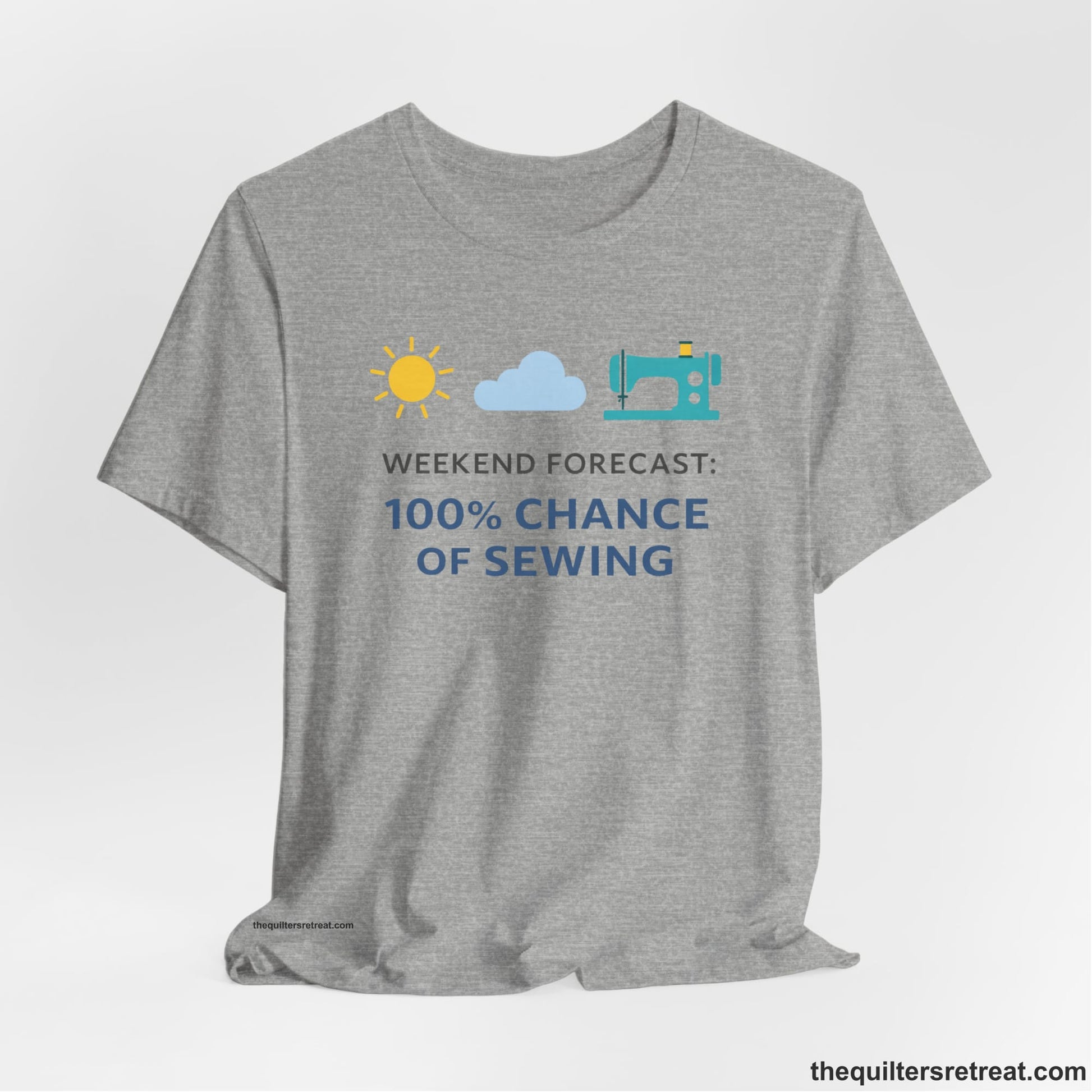 A Athletic Heather Short Sleeve T-Shirt with a Sun, cloud, sewing machine icons; bold text "Weekend Forecast: 100% Chance of Sewing"; playful style.
