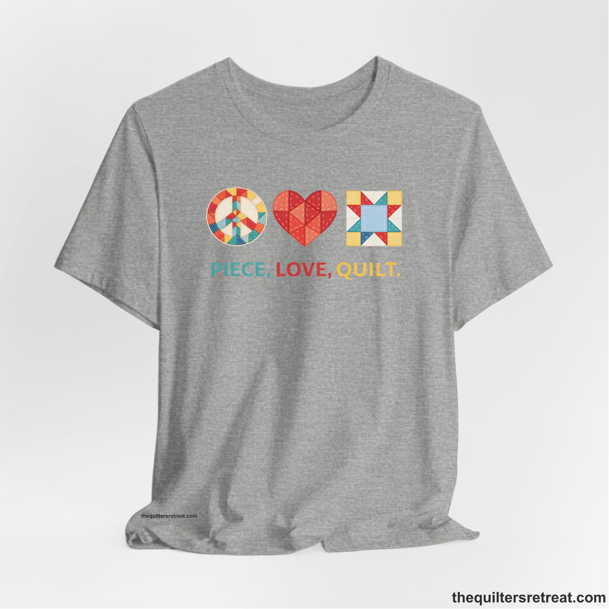A Athletic Heather Short Sleeve T-Shirt with a Colorful quilt patterns, "PIECE, LOVE, QUILT." text, whimsical style.