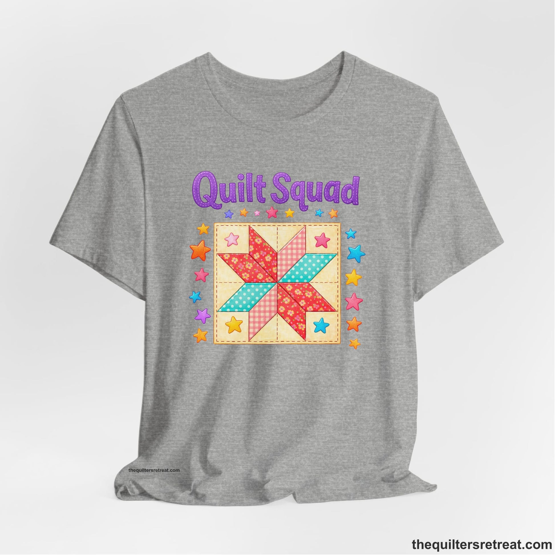 A Athletic Heather Short Sleeve T-Shirt with a Patchwork quilt star with colorful stars, playful mood, "Quilt Squad" text.