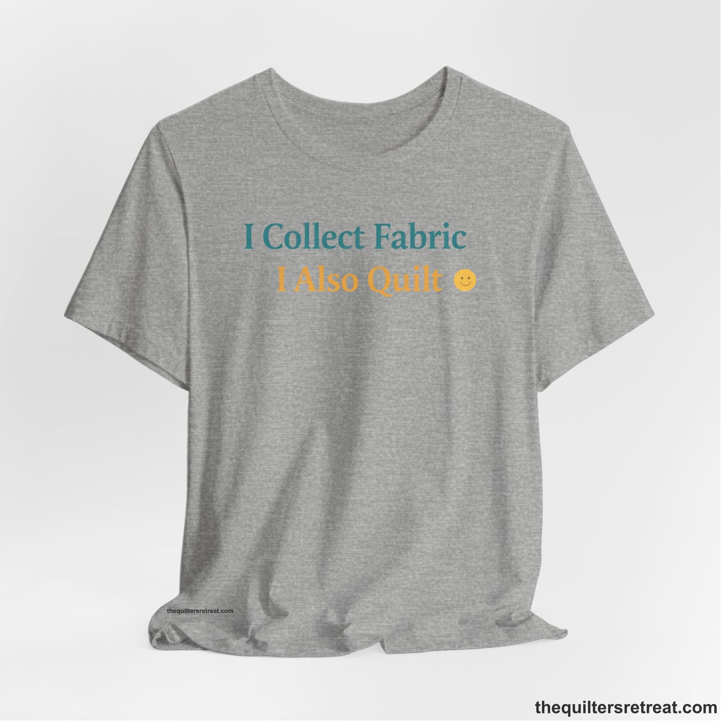 A Athletic Heather Short Sleeve T-Shirt with a Colorful text saying "I Collect Fabric I Also Quilt" with a playful, cheerful vibe.