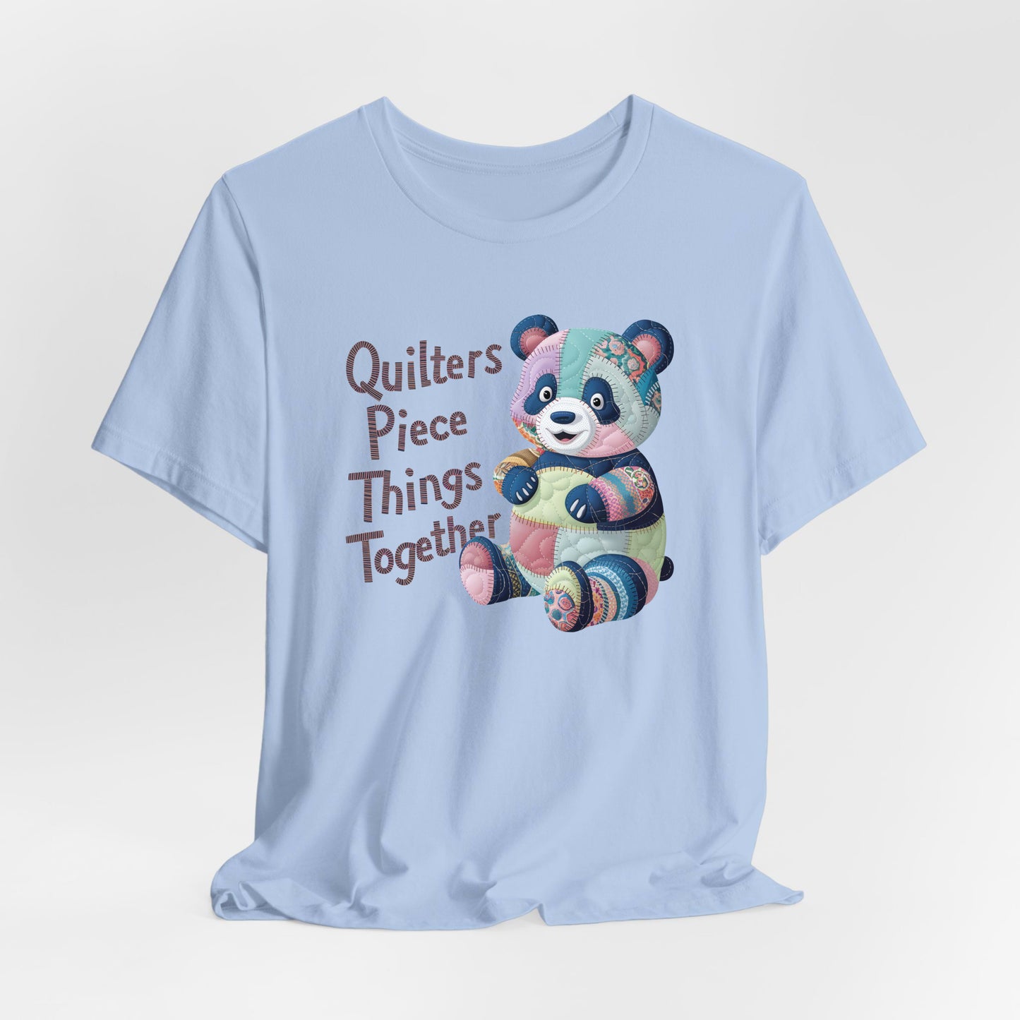 A Baby Blue Short Sleeve T-Shirt with a patchwork panda with "Quilters Piece Things Together" text in a whimsical style