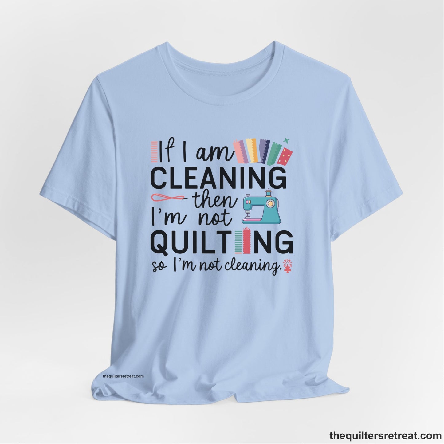 A Baby Blue Short Sleeve T-Shirt with a If I am cleaning then I'm not quilting text with sewing machine and fabric graphics