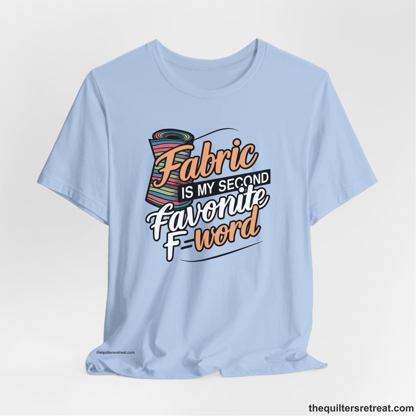 A Baby Blue Short Sleeve T-Shirt with a fabric bolt illustration with bold "Fabric Is My Second Favorite F Word" text