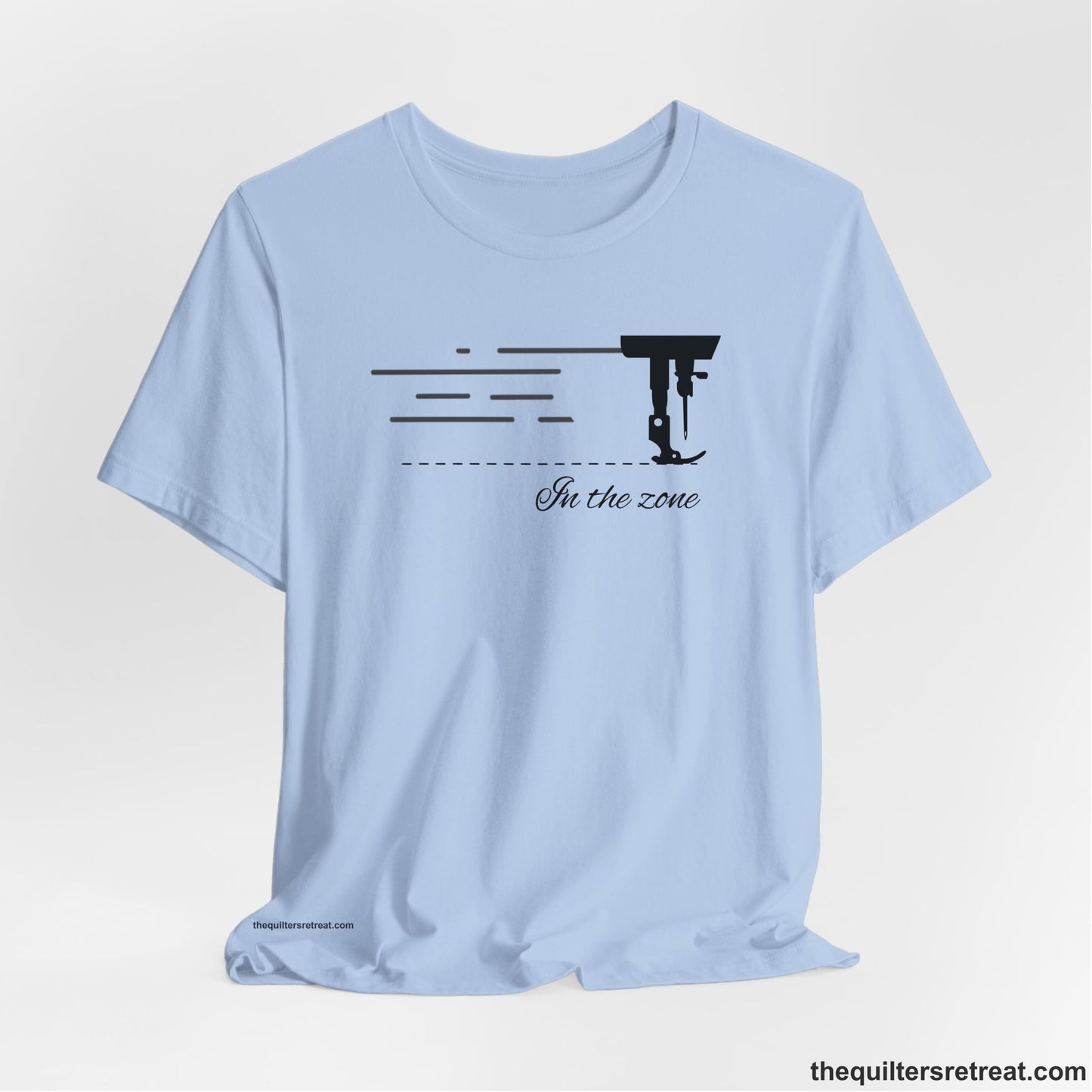 A Baby Blue Short Sleeve T-Shirt with a vintage sewing machine illustration with floral accents and "Sewing Mends the Soul" text