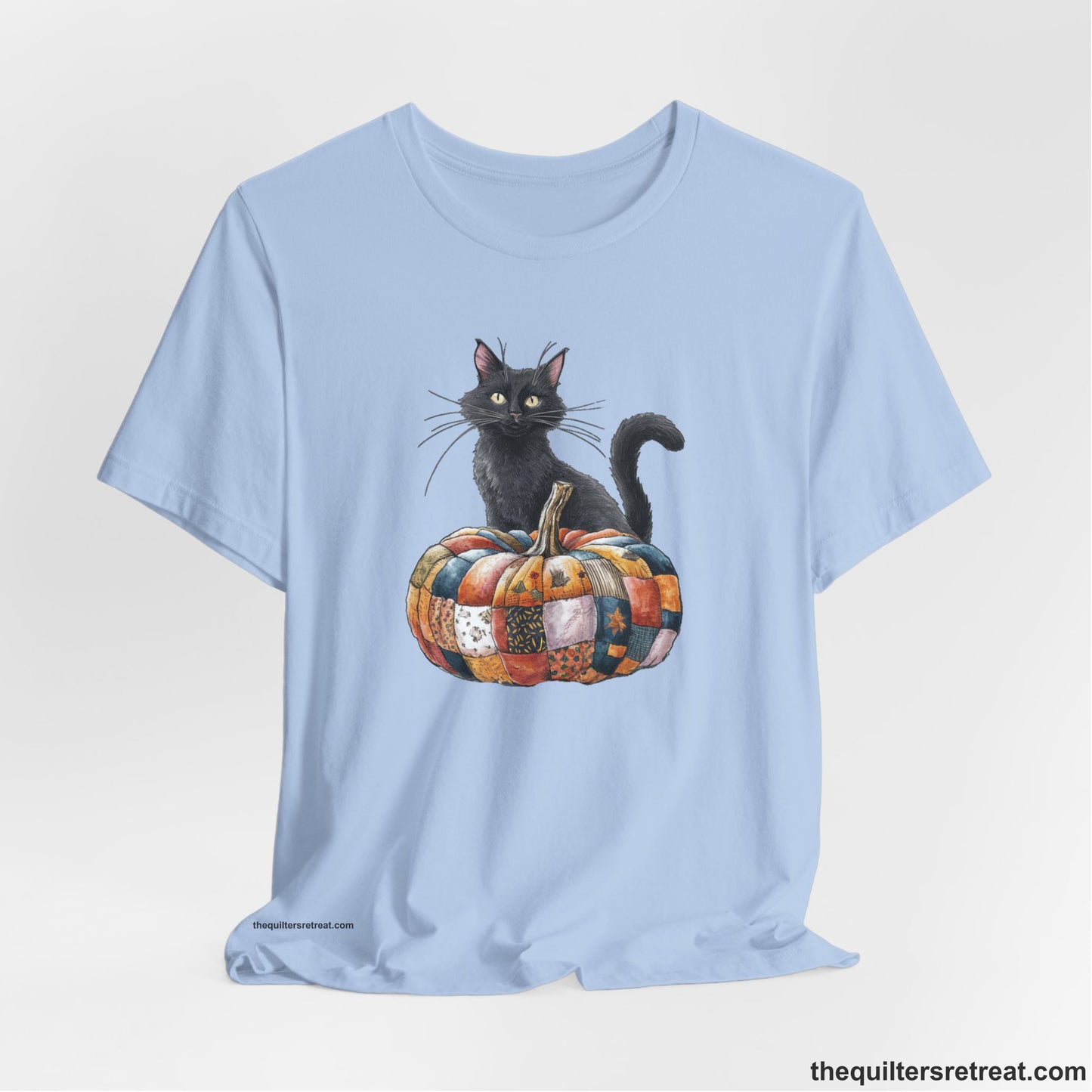 A Baby Blue Short Sleeve T-Shirt with a black cat with a quilted patchwork pumpkin in a whimsical autumn style