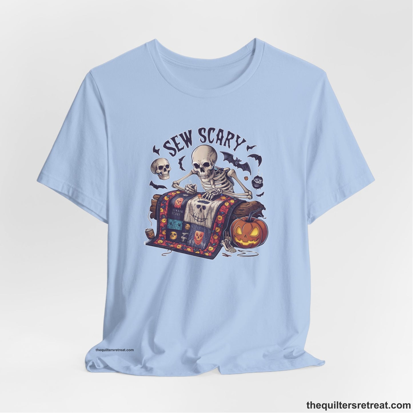 A Baby Blue Short Sleeve T-Shirt with a skeleton quilting with spooky accents and "Sew Scary" text in a Halloween theme