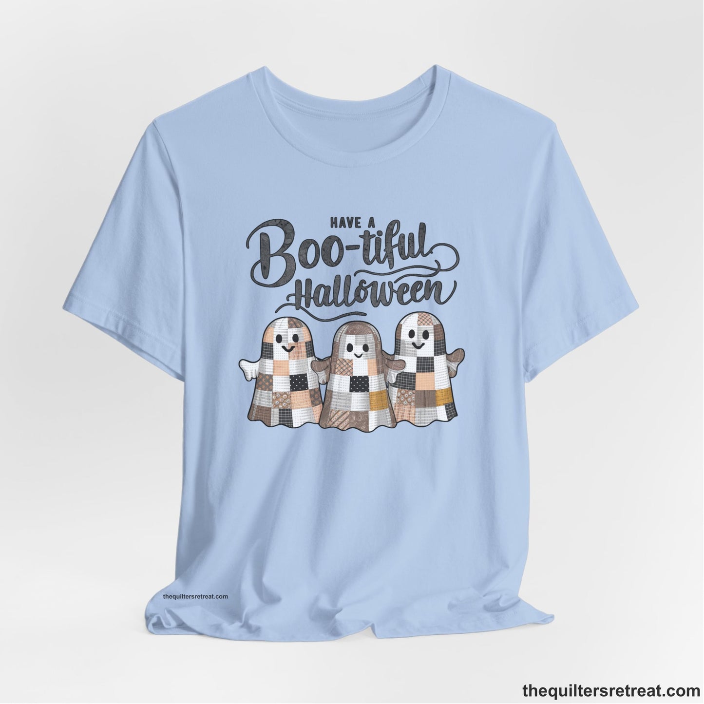 A Baby Blue Short Sleeve T-Shirt with a cute patchwork ghosts with "Boo-tiful Halloween" text in a playful style