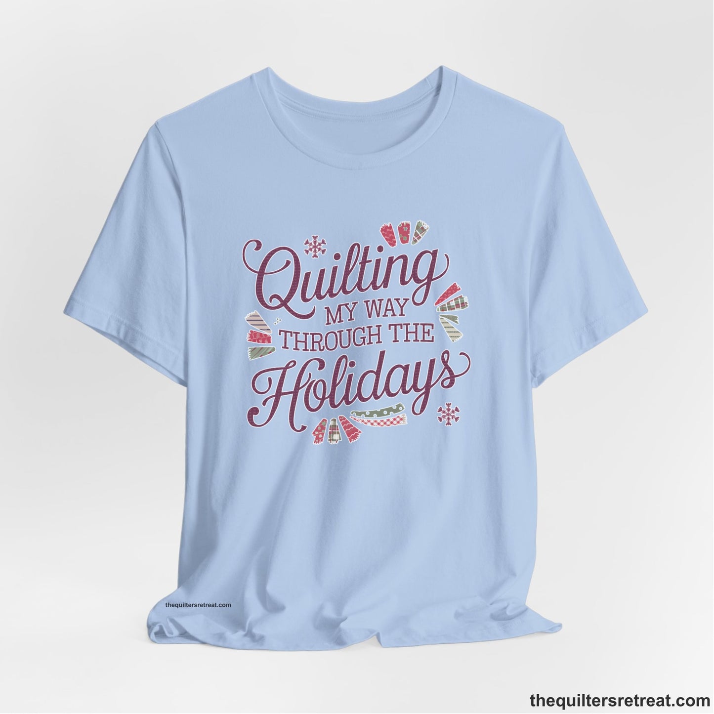 A Baby Blue Short Sleeve T-Shirt with a quilting-themed text in festive colors with decorative quilt patterns