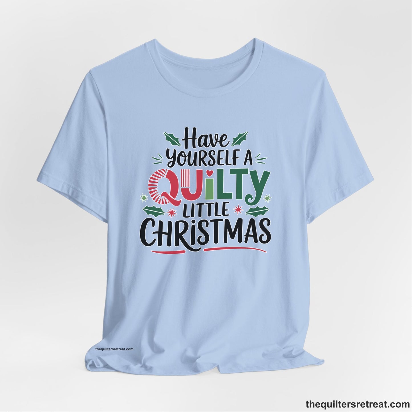 A Baby Blue Short Sleeve T-Shirt with a festive "Have Yourself a Quilty Little Christmas" text with holly and quilt patterns