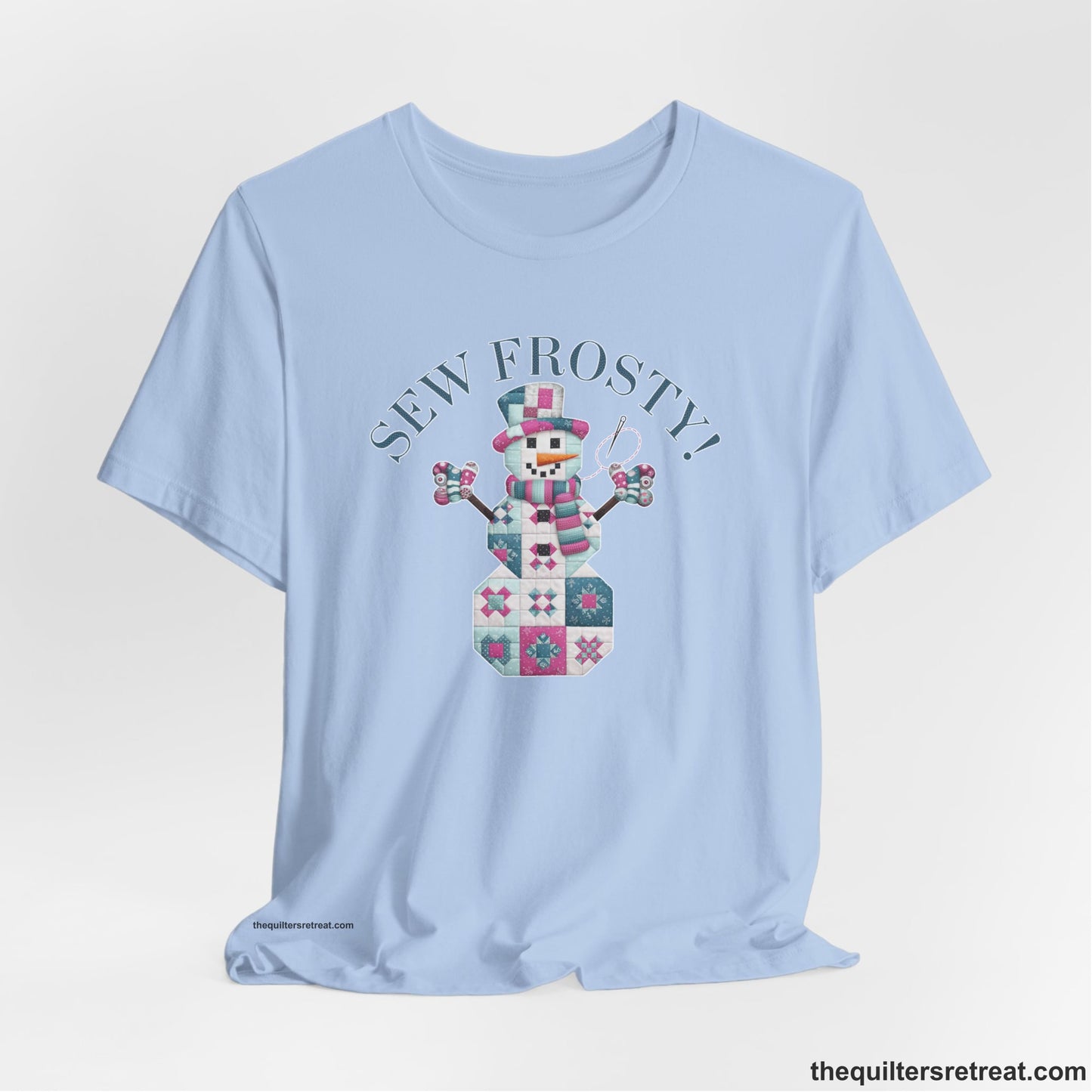 A Baby Blue Short Sleeve T-Shirt with a snowman quilt pattern with "Sew Frosty!" text in a crafty style