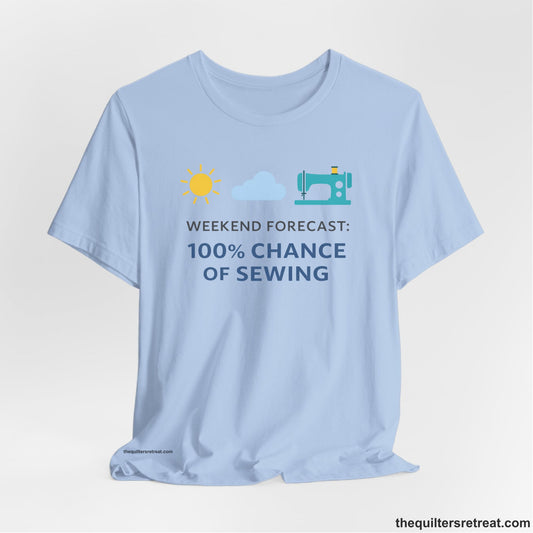 A Baby Blue Short Sleeve T-Shirt with a Sun, cloud, sewing machine icons; bold text "Weekend Forecast: 100% Chance of Sewing"; playful style.