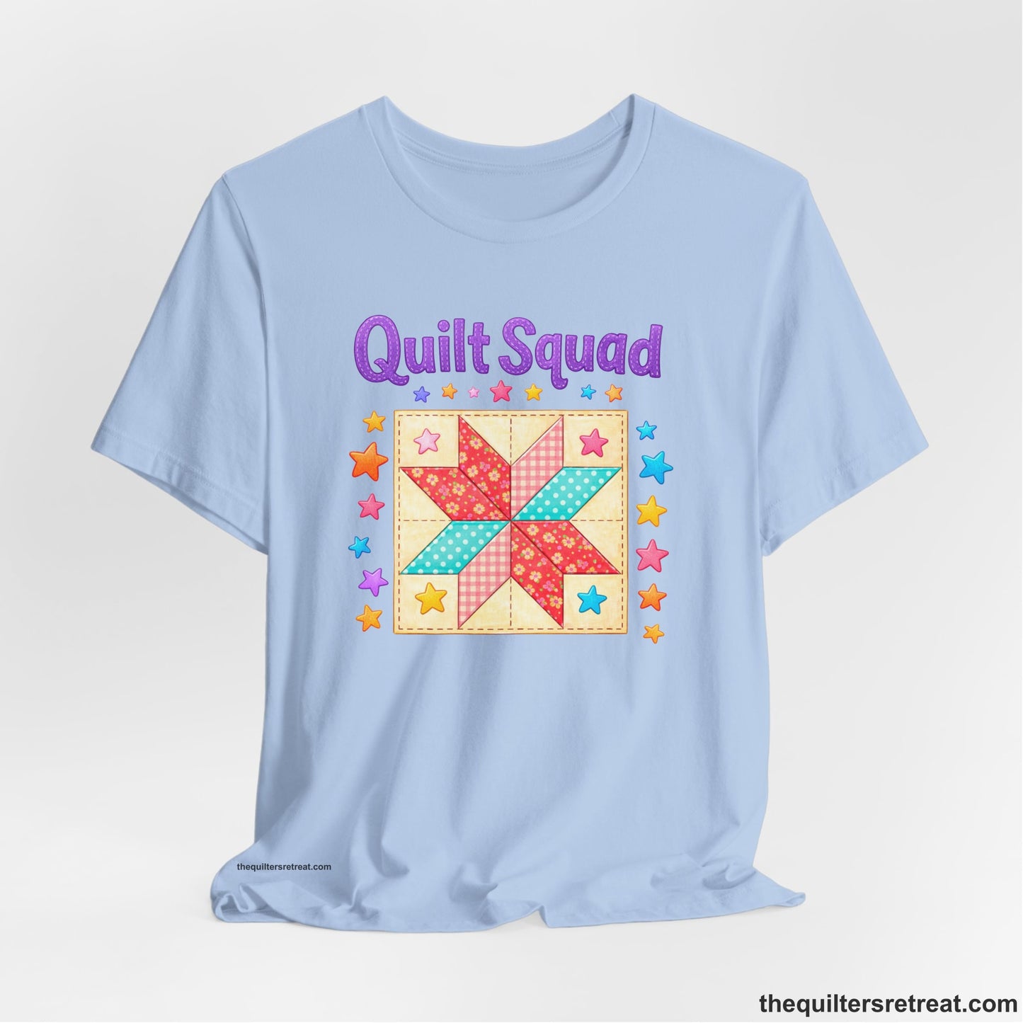 A Baby Blue Short Sleeve T-Shirt with a Patchwork quilt star with colorful stars, playful mood, "Quilt Squad" text.