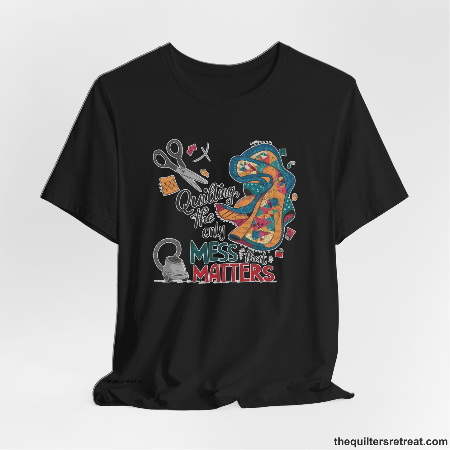 A Black Short Sleeve T-Shirt with a quilting tools and patchwork pieces with bold "Quilting, the only mess that matters" text