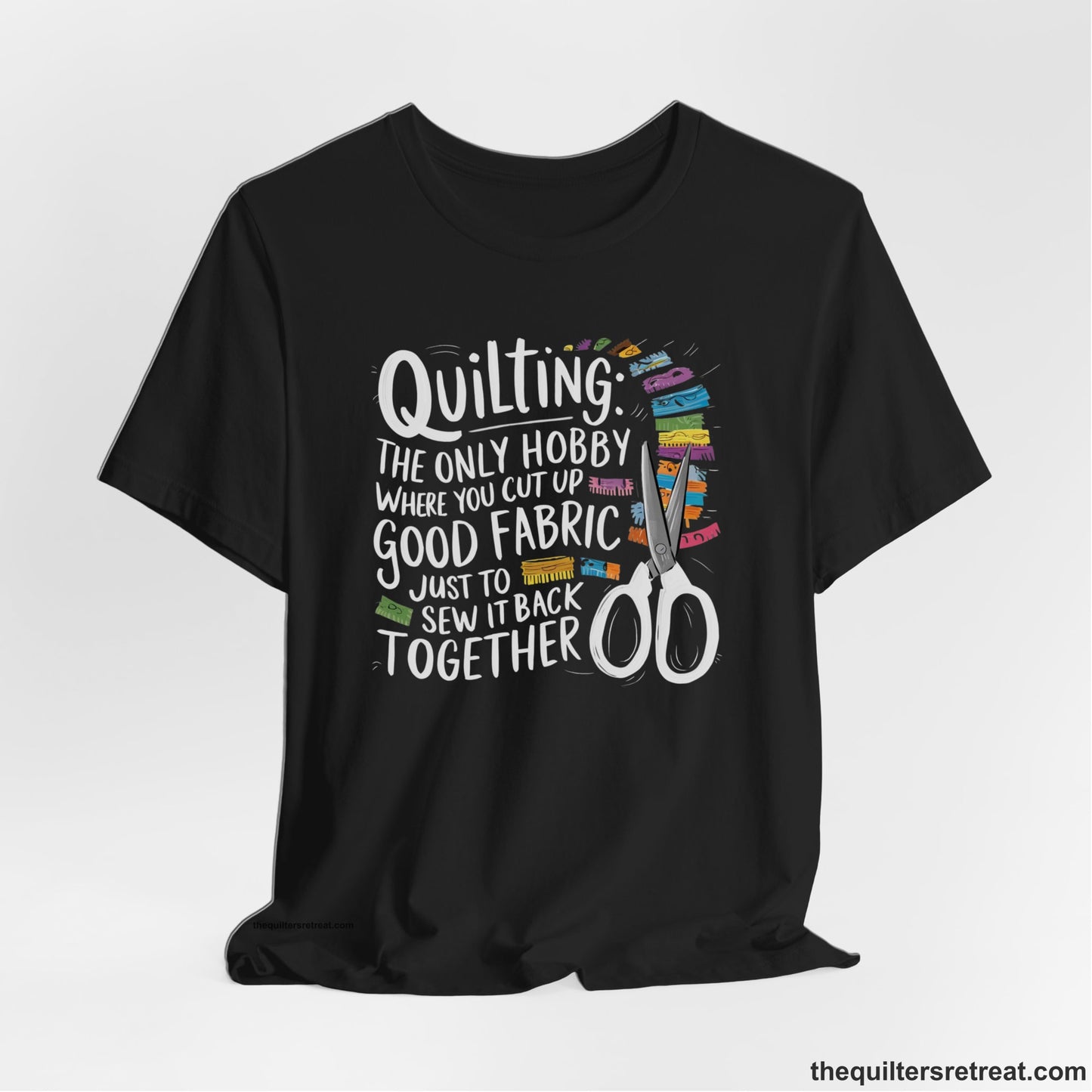 A Black Short Sleeve T-Shirt with a quilting-themed text with colorful fabric pieces and scissors in a whimsical style