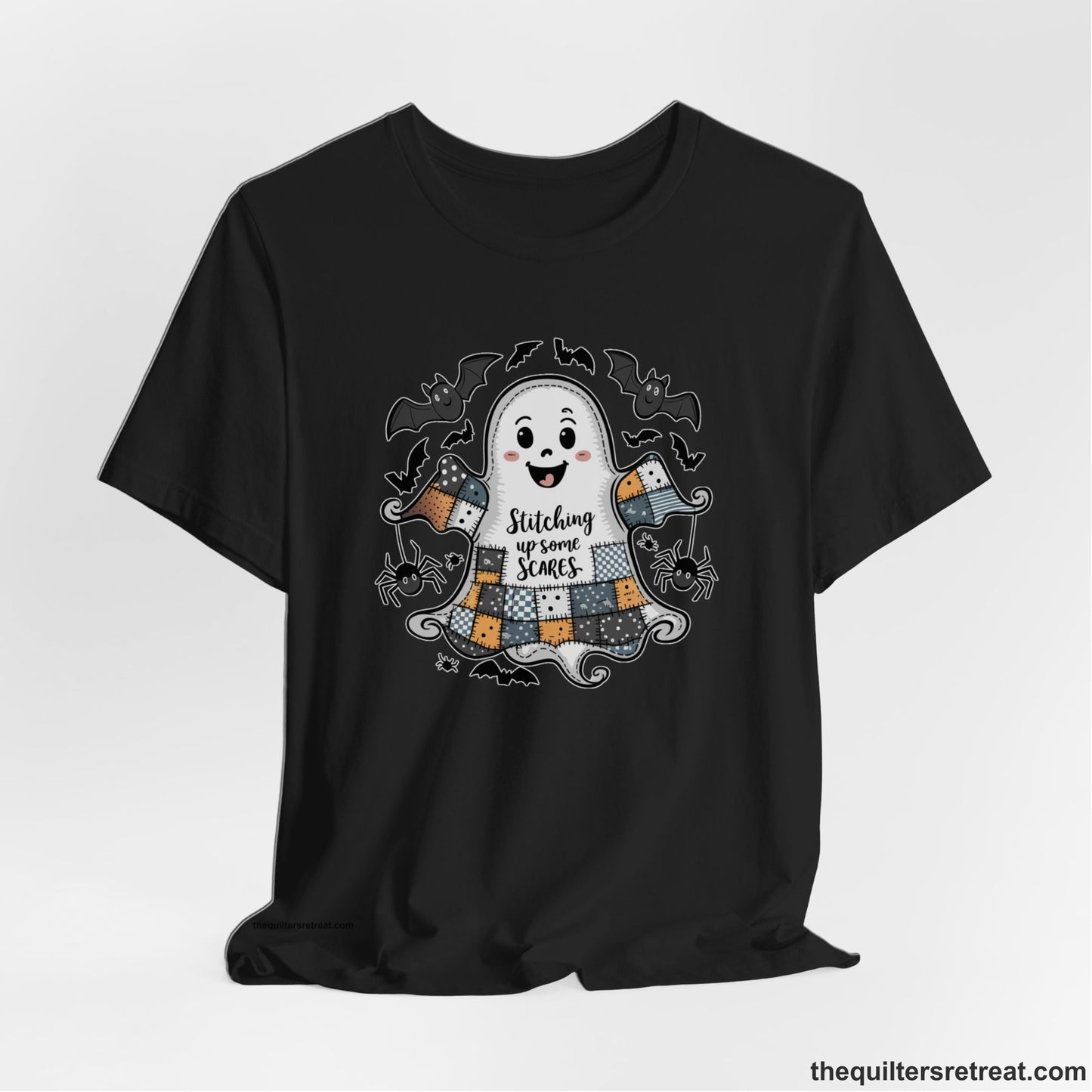 A Black Short Sleeve T-Shirt with a cute patchwork ghost with "Stitching up some Scares" text and playful bats in a whimsical style