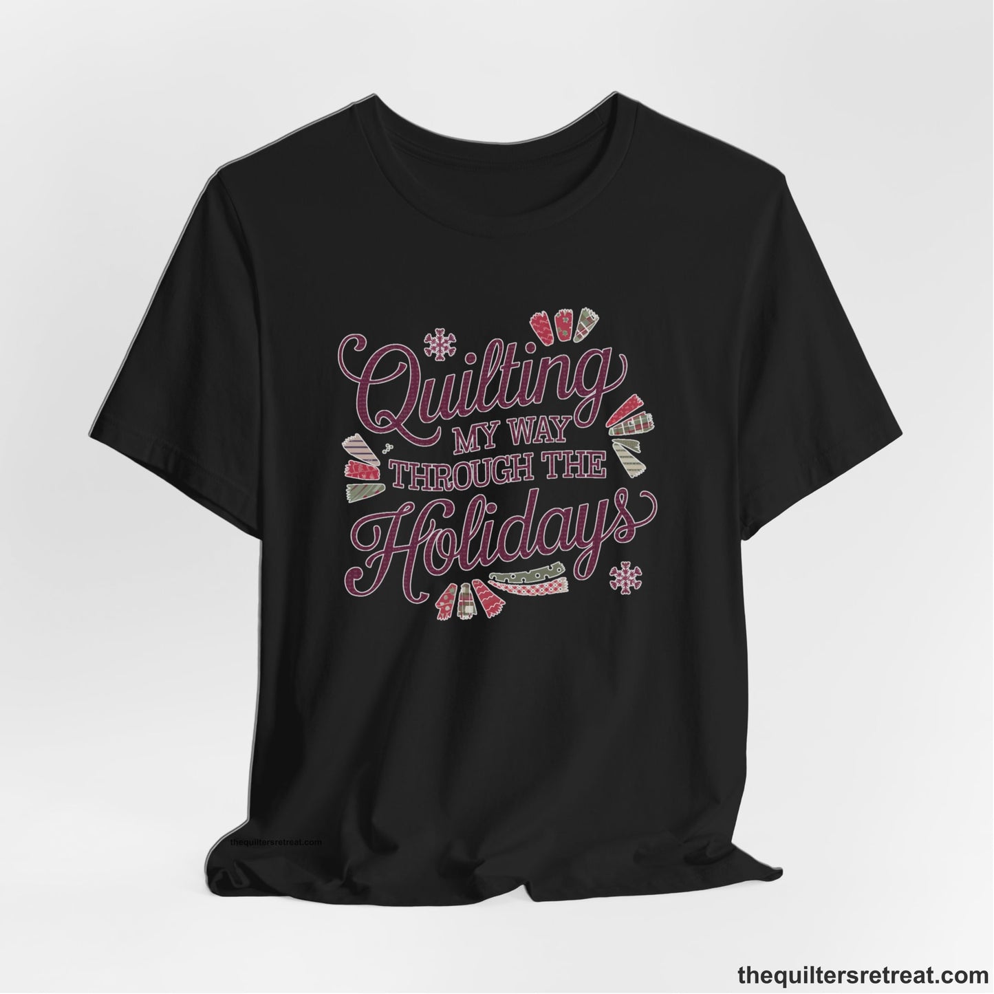 A Black Short Sleeve T-Shirt with a quilting-themed text in festive colors with decorative quilt patterns