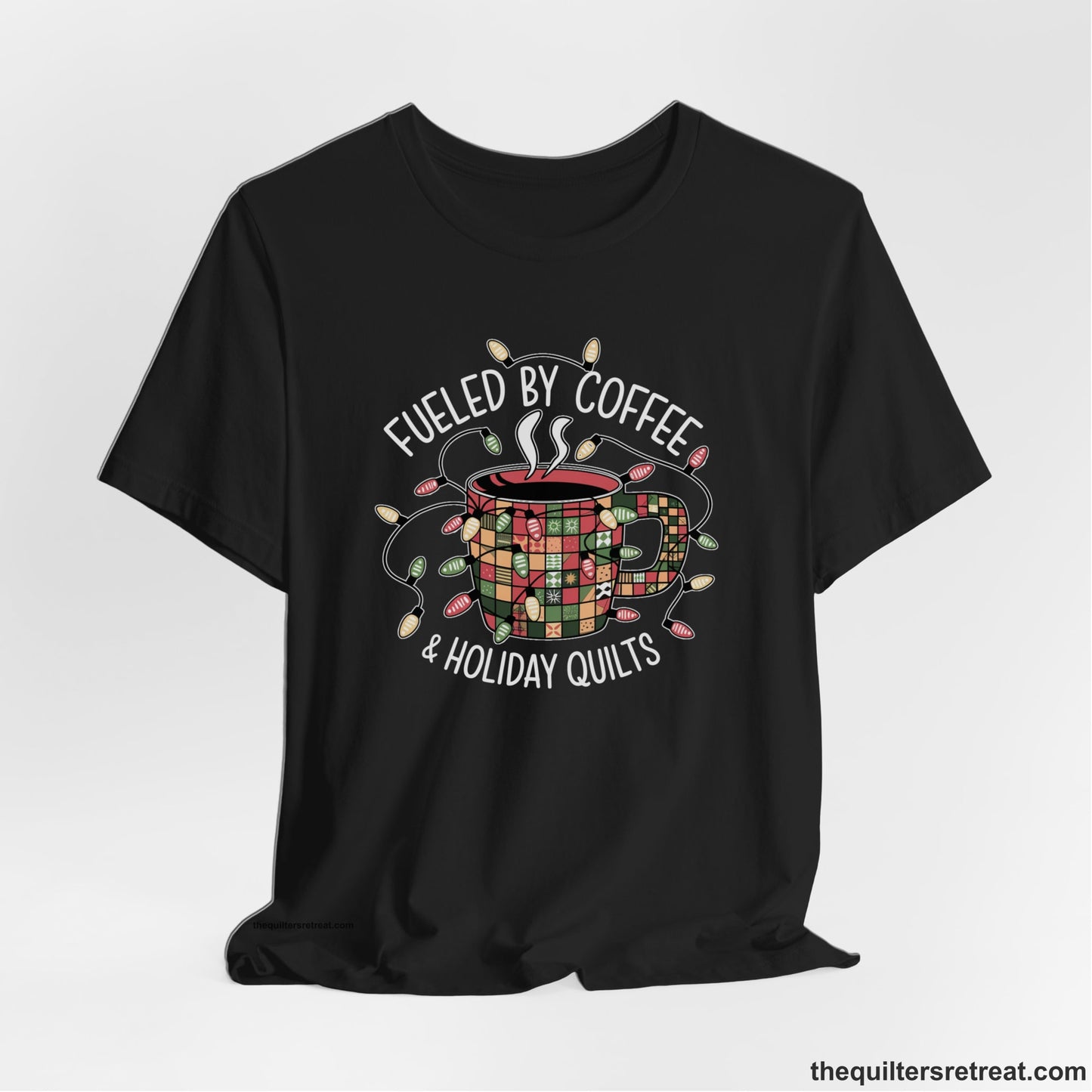 A Black Short Sleeve T-Shirt with a patchwork coffee mug with colorful lights and subtle "Fueled by Coffee" text in festive style