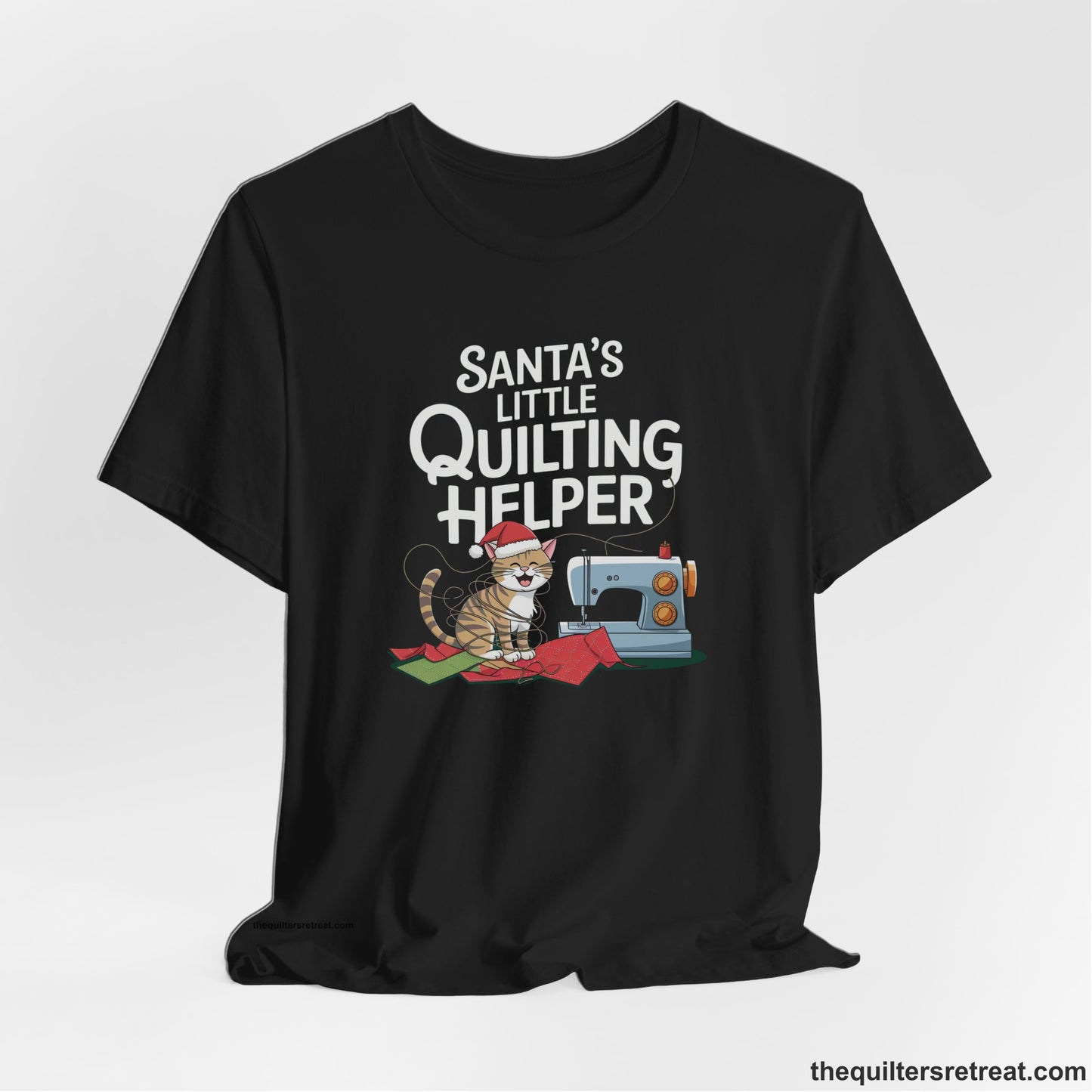 A Black Short Sleeve T-Shirt with a santa-hat-wearing kitten with a sewing machine and "Santa's Little Quilting Helper" text in playful style