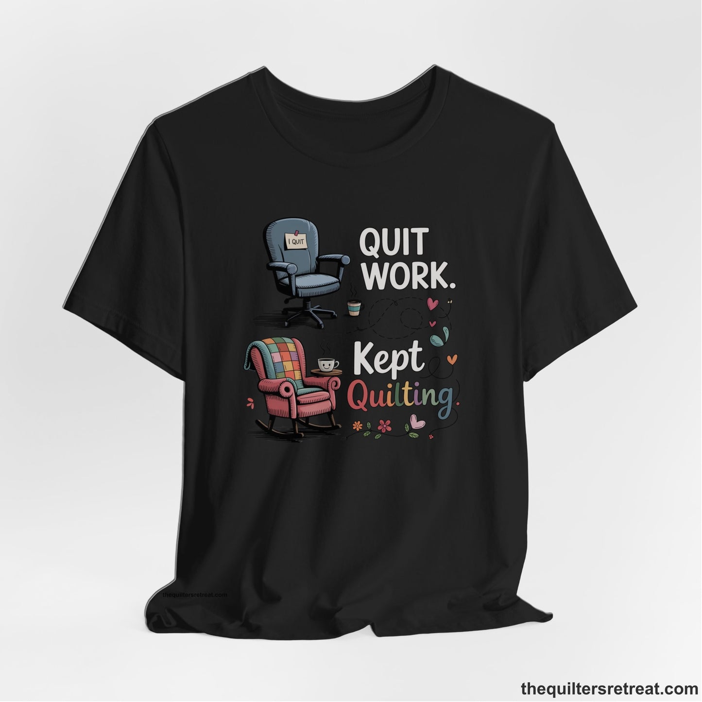 A Black Short Sleeve T-Shirt with a quit work kept quilting text with cozy chairs and colorful floral accents in a whimsical style