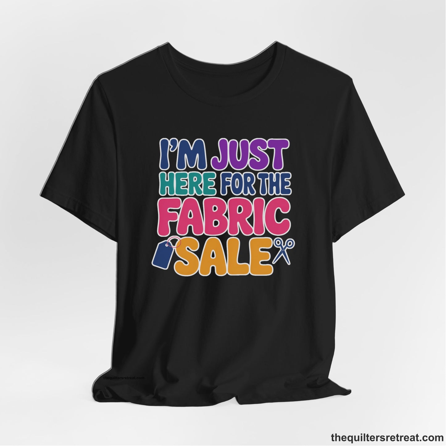A Black Short Sleeve T-Shirt with a playful "I'm Just Here for the Fabric Sale" text with colorful letters and sewing icons