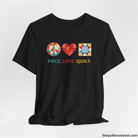 A Black Short Sleeve T-Shirt with a Colorful quilt patterns, "PIECE, LOVE, QUILT." text, whimsical style.