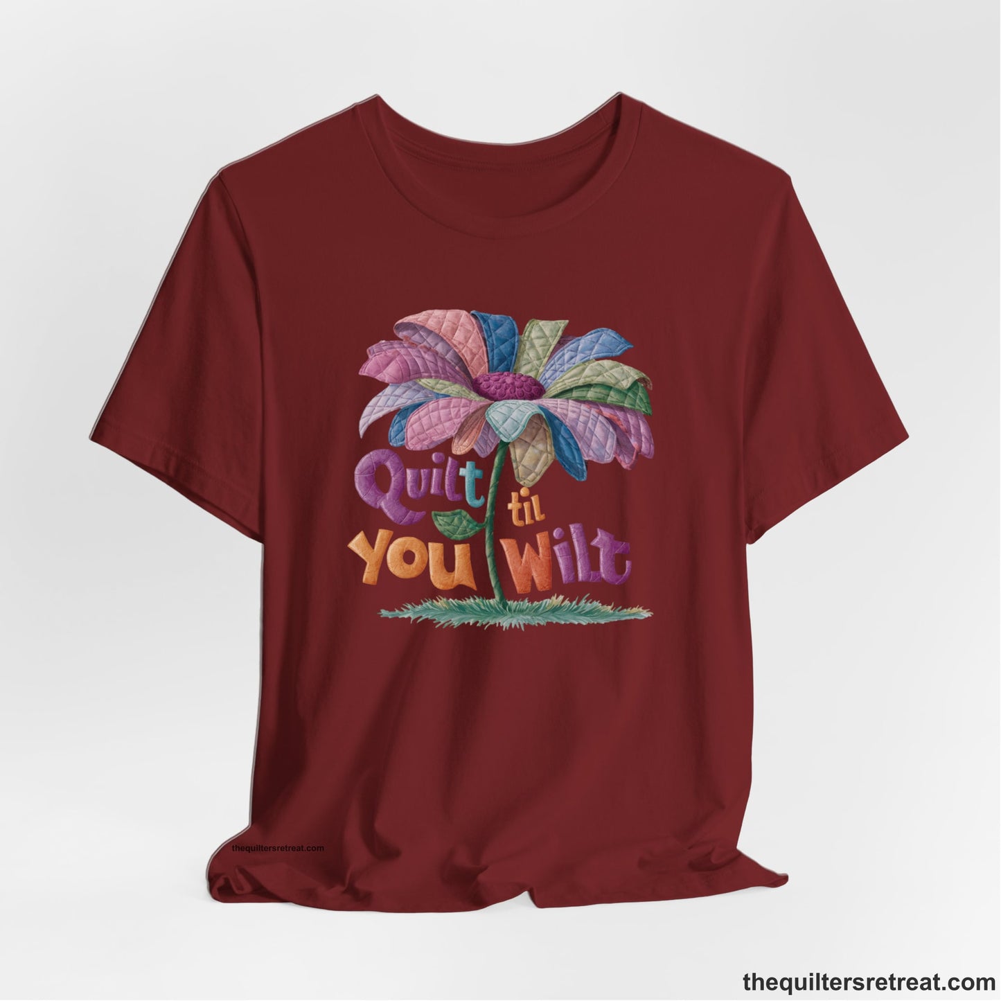 A Cardinal Short Sleeve T-Shirt with a whimsical quilted flower with bold "Quilt til You Wilt" text