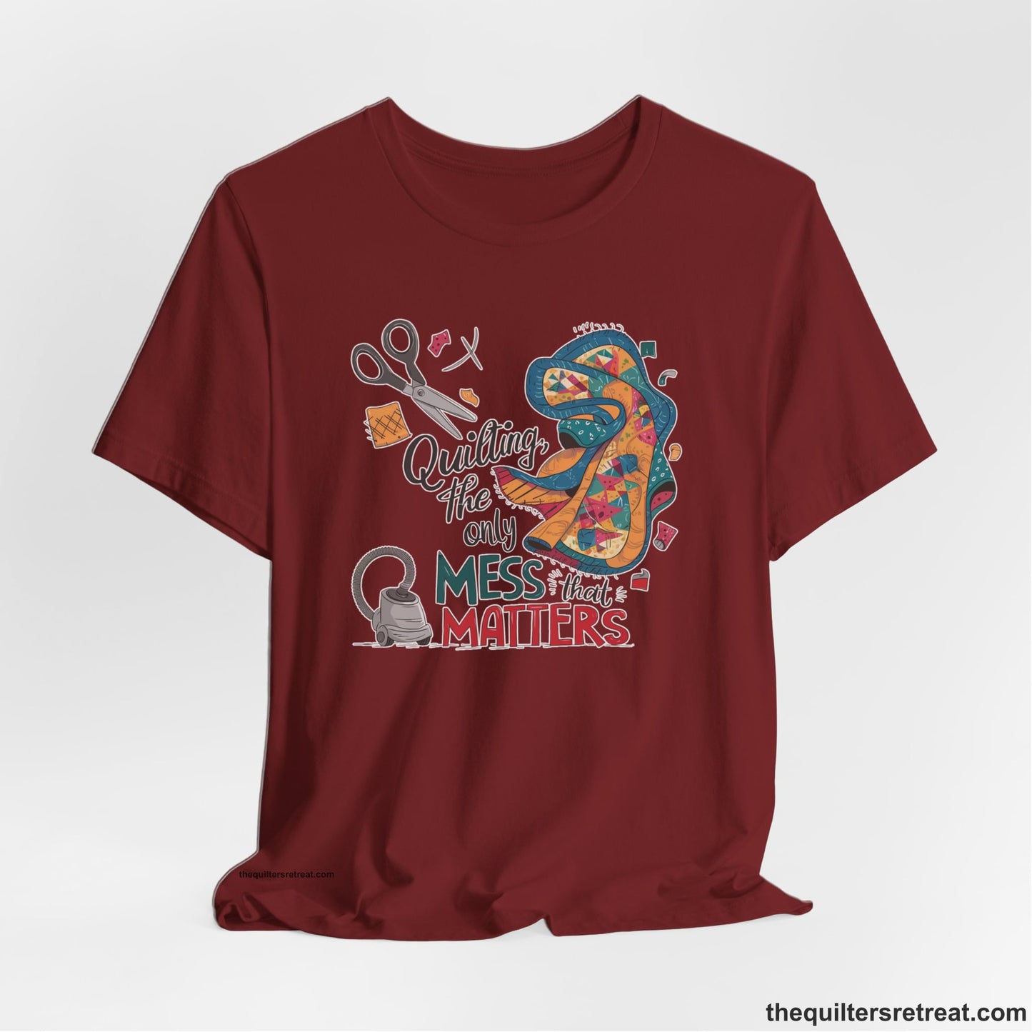 A Cardinal Short Sleeve T-Shirt with a quilting tools and patchwork pieces with bold "Quilting, the only mess that matters" text