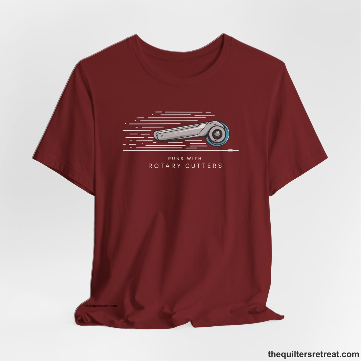 A Cardinal Short Sleeve T-Shirt with a rotary cutter illustration with dynamic lines and bold "Runs with Rotary Cutters" text