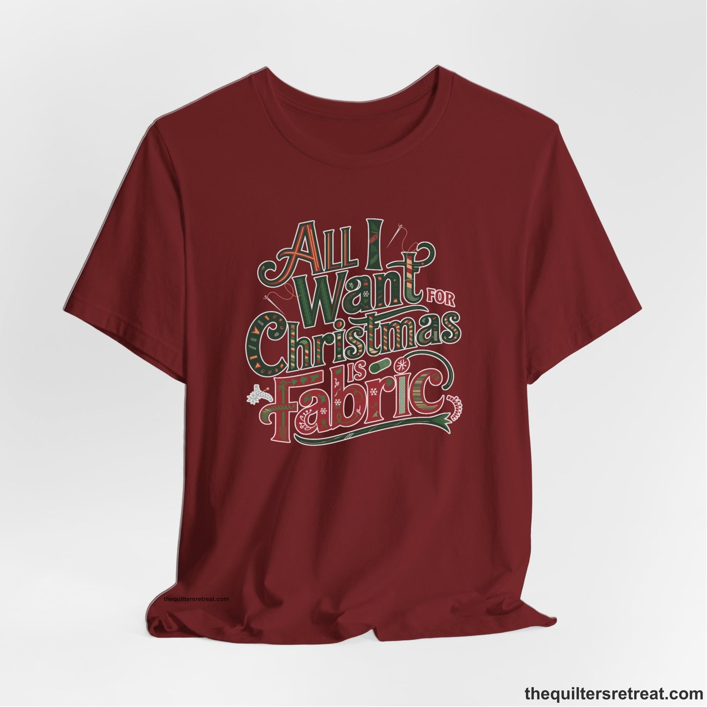 A Cardinal Short Sleeve T-Shirt with a vintage holiday text "All I Want for Christmas is Fabric" with festive motifs