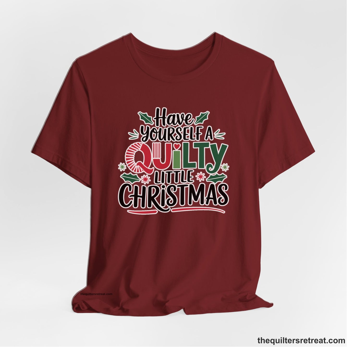 A Cardinal Short Sleeve T-Shirt with a festive "Have Yourself a Quilty Little Christmas" text with holly and quilt patterns