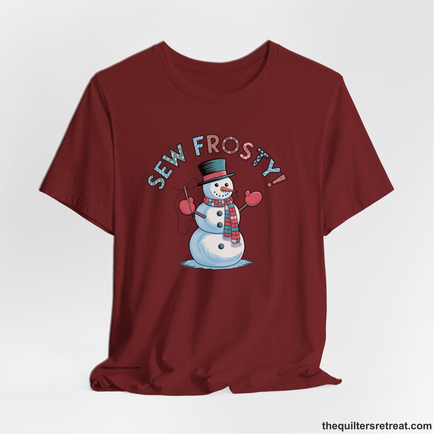 A Cardinal Short Sleeve T-Shirt with a playful snowman sewing illustration with "Sew Frosty!" text in a festive style