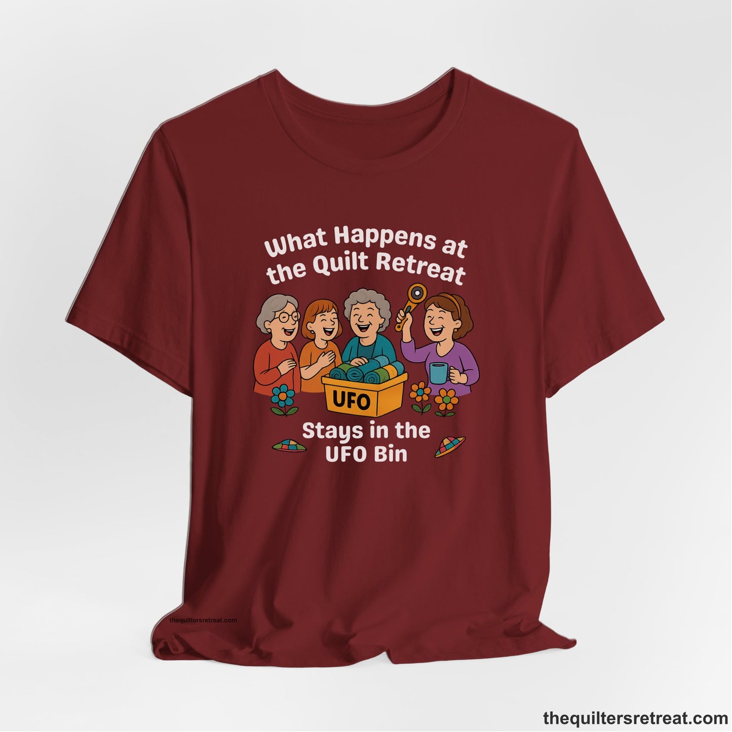 A Cardinal Short Sleeve T-Shirt with a four smiling women with unfinished fabric objects and playful "UFO" text in a cartoon style