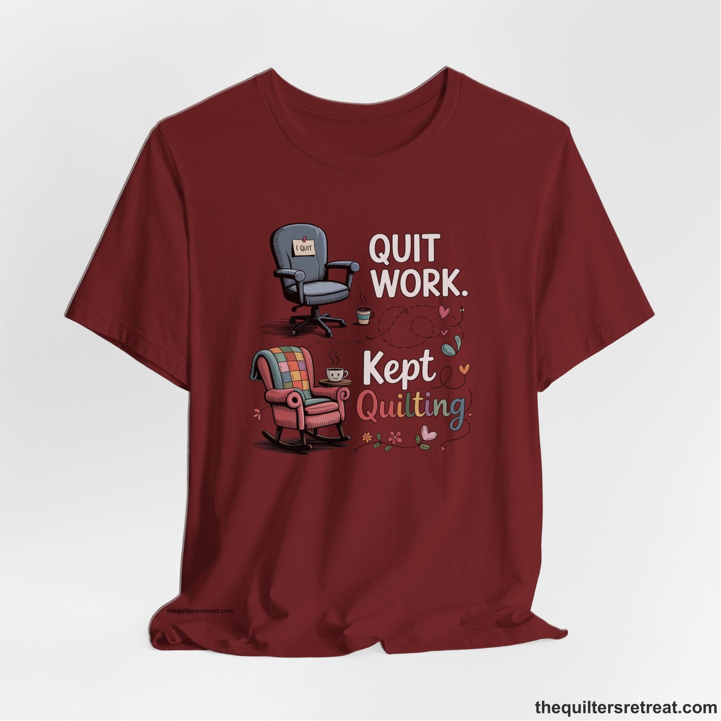 A Cardinal Short Sleeve T-Shirt with a quit work kept quilting text with cozy chairs and colorful floral accents in a whimsical style