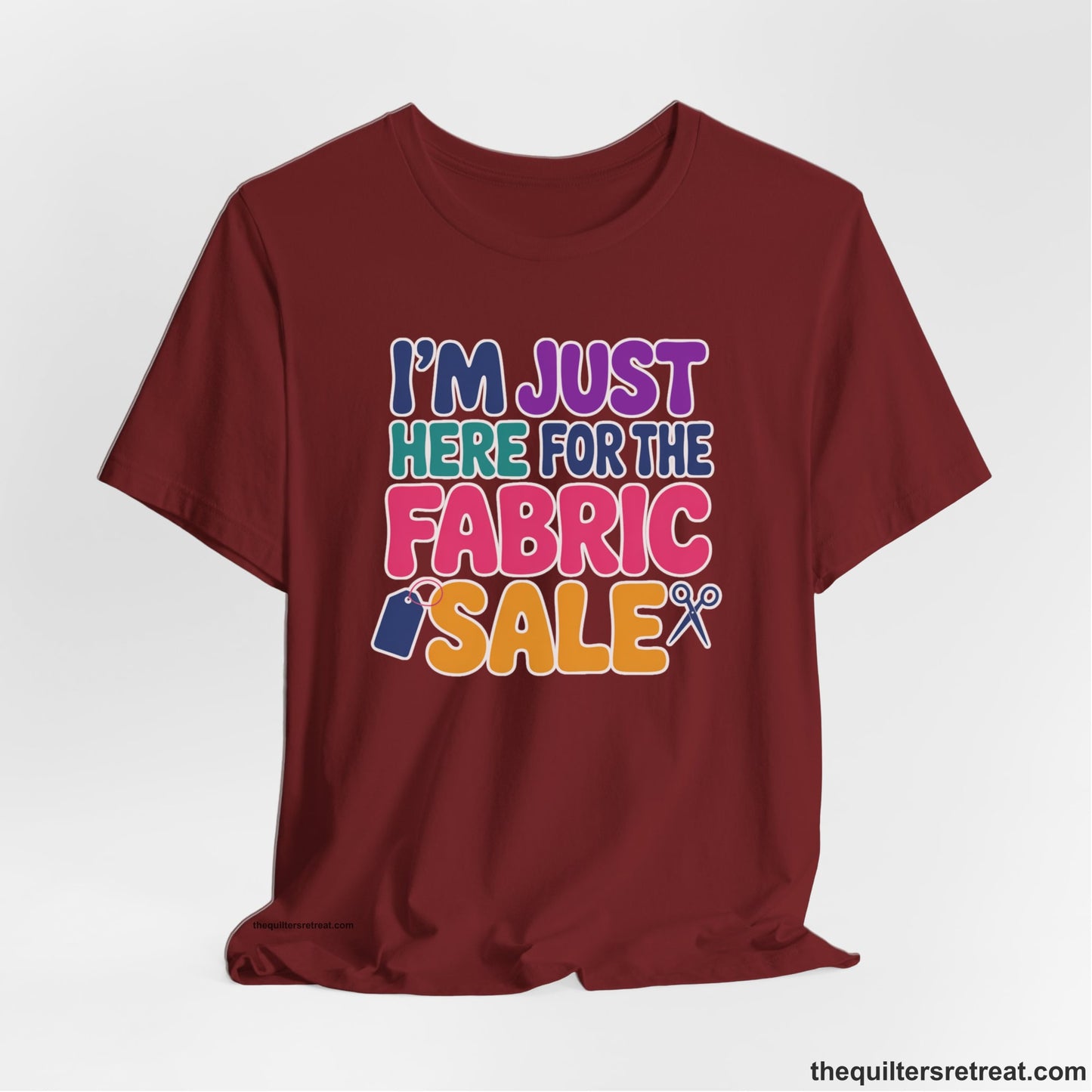 A Cardinal Short Sleeve T-Shirt with a playful "I'm Just Here for the Fabric Sale" text with colorful letters and sewing icons
