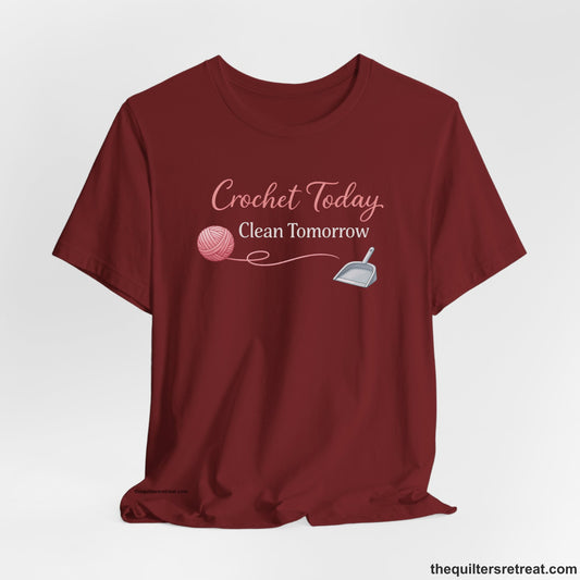 A Cardinal Short Sleeve T-Shirt with a Pink yarn ball and scoop with playful text "Crochet Today, Clean Tomorrow".
