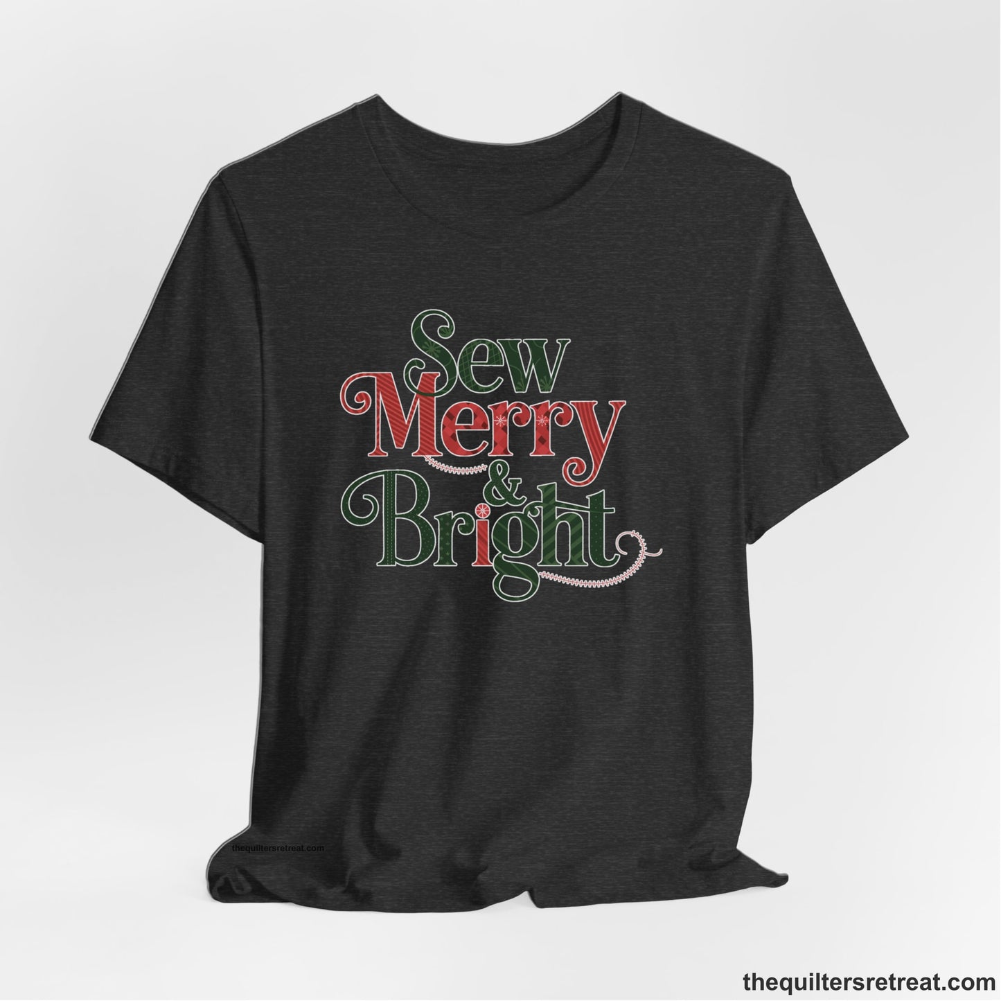 A Dark Grey Heather Short Sleeve T-Shirt with a festive "Sew Merry & Bright" text with decorative holiday patterns