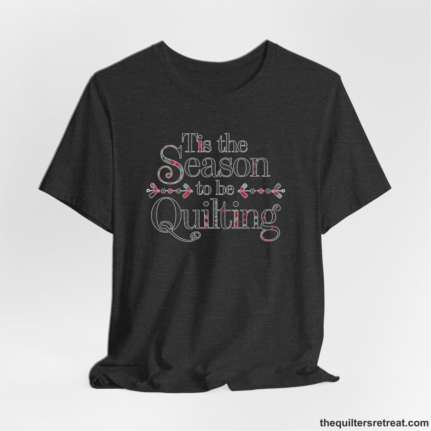 A Dark Grey Heather Short Sleeve T-Shirt with a tis the season to be quilting text with festive patchwork pattern in a cheerful style