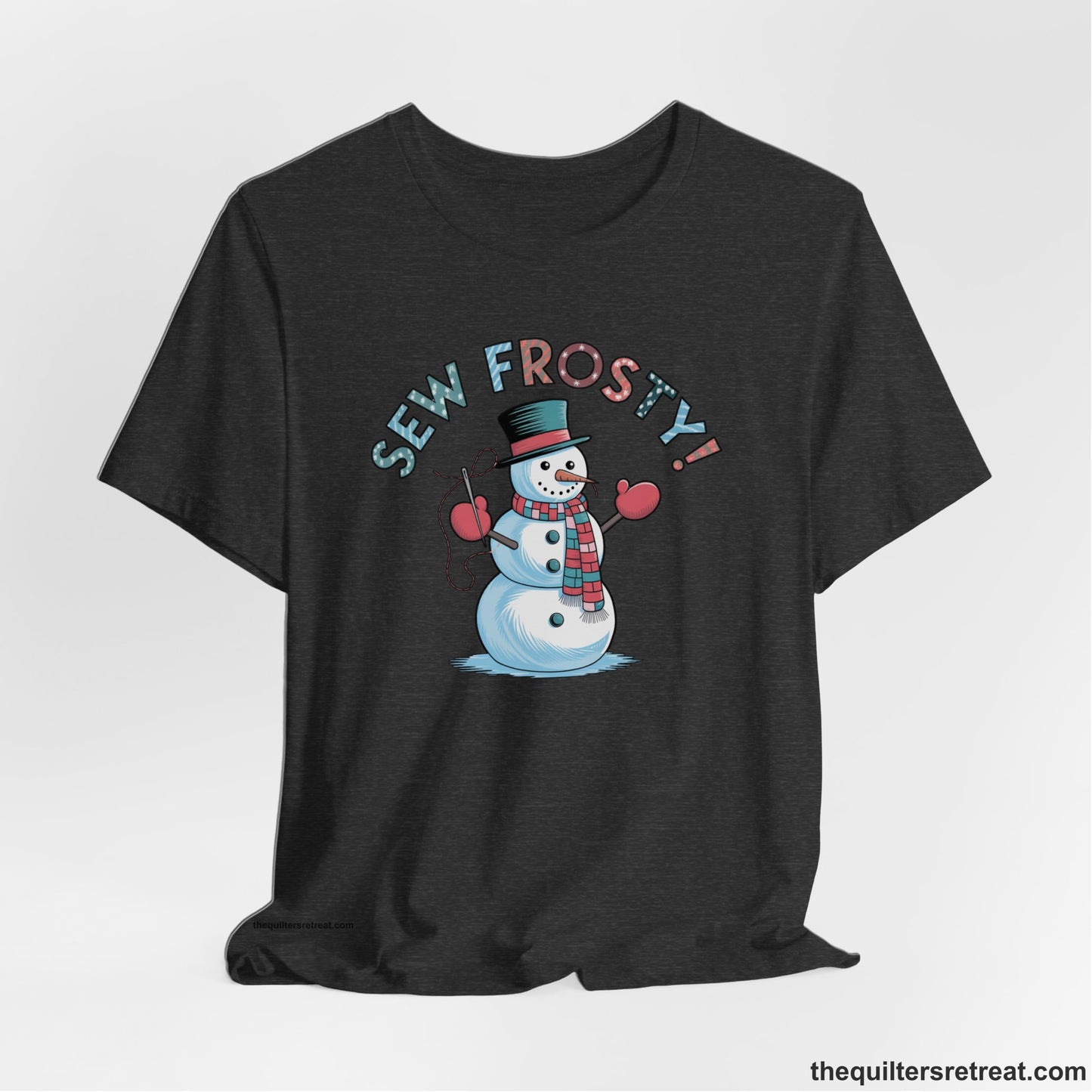 A Dark Grey Heather Short Sleeve T-Shirt with a playful snowman sewing illustration with "Sew Frosty!" text in a festive style