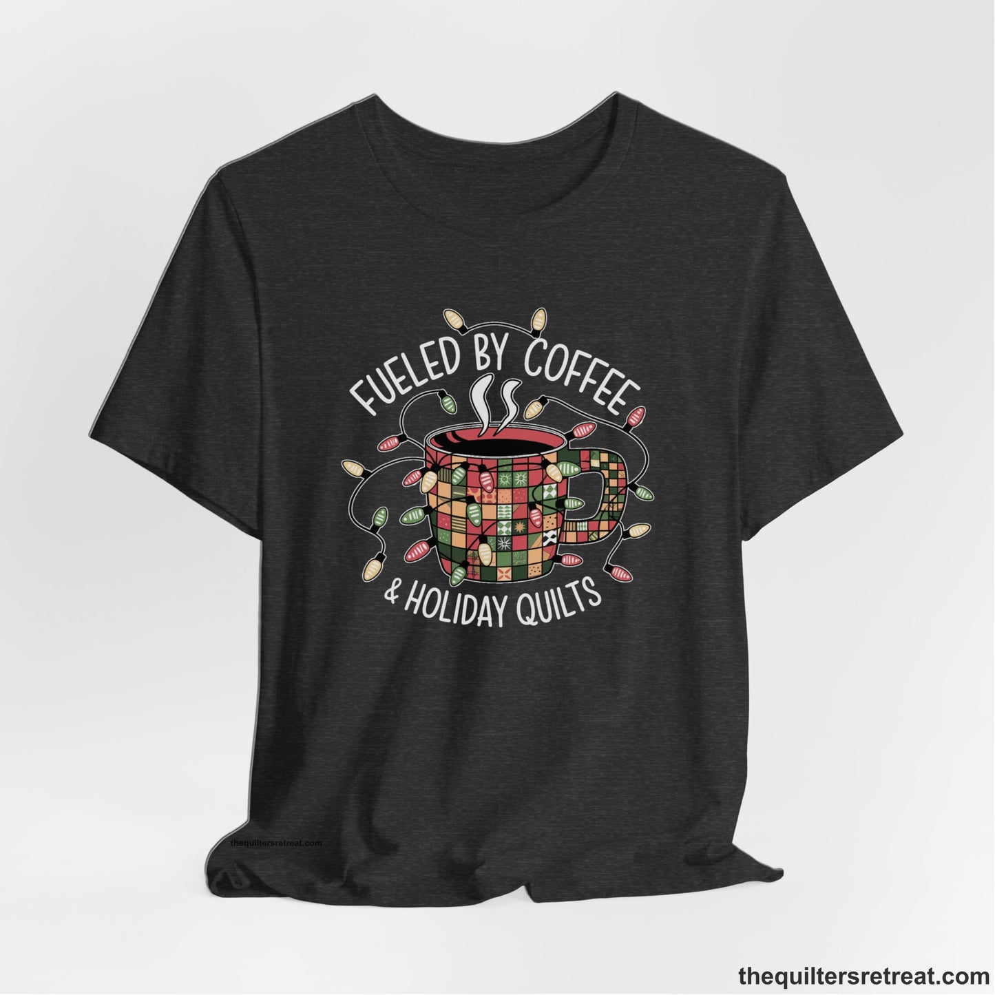 A Dark Grey Heather Short Sleeve T-Shirt with a patchwork coffee mug with colorful lights and subtle "Fueled by Coffee" text in festive style