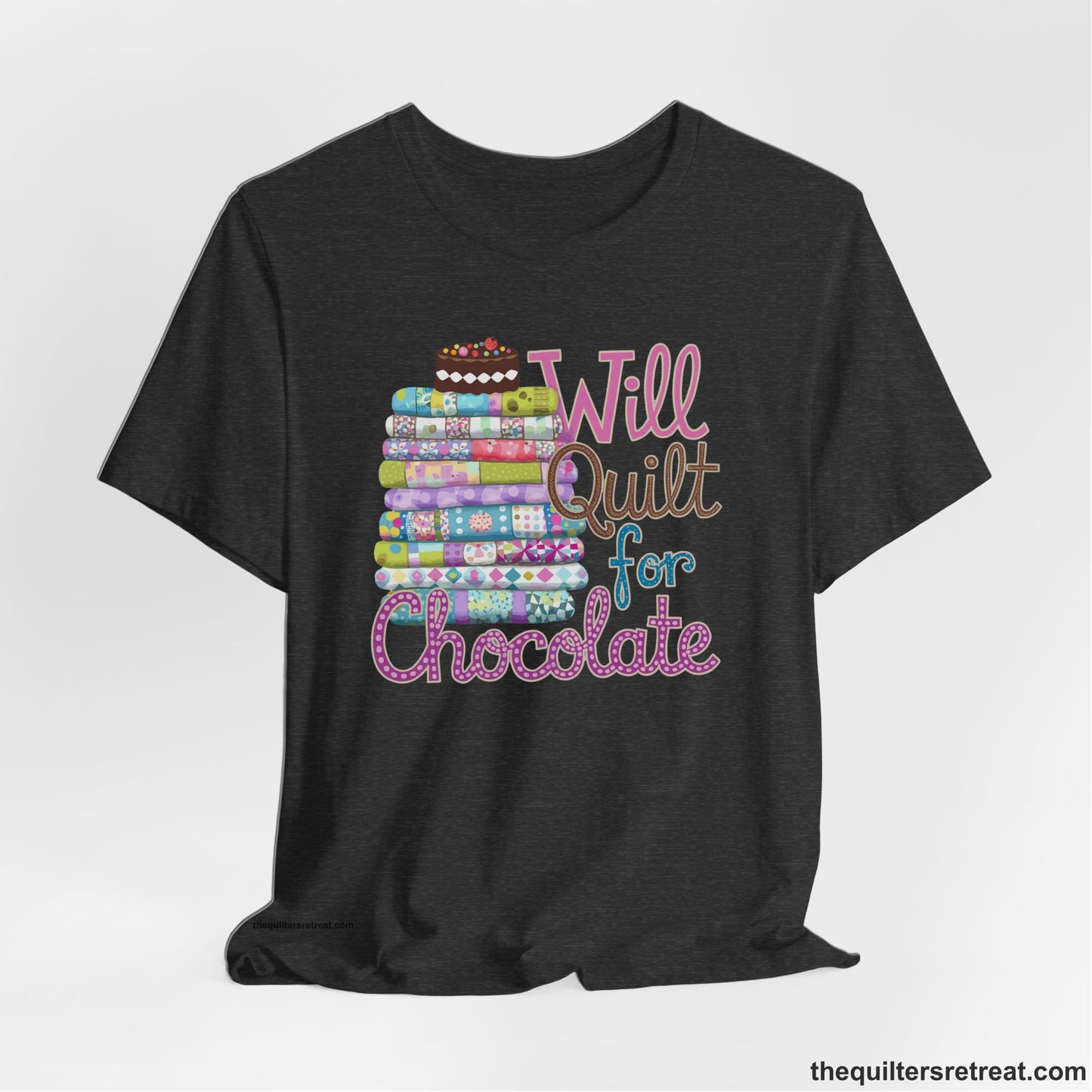 A Dark Grey Heather Short Sleeve T-Shirt with a stack of colorful quilts topped with cake, whimsical "Will Quilt for Chocolate" text