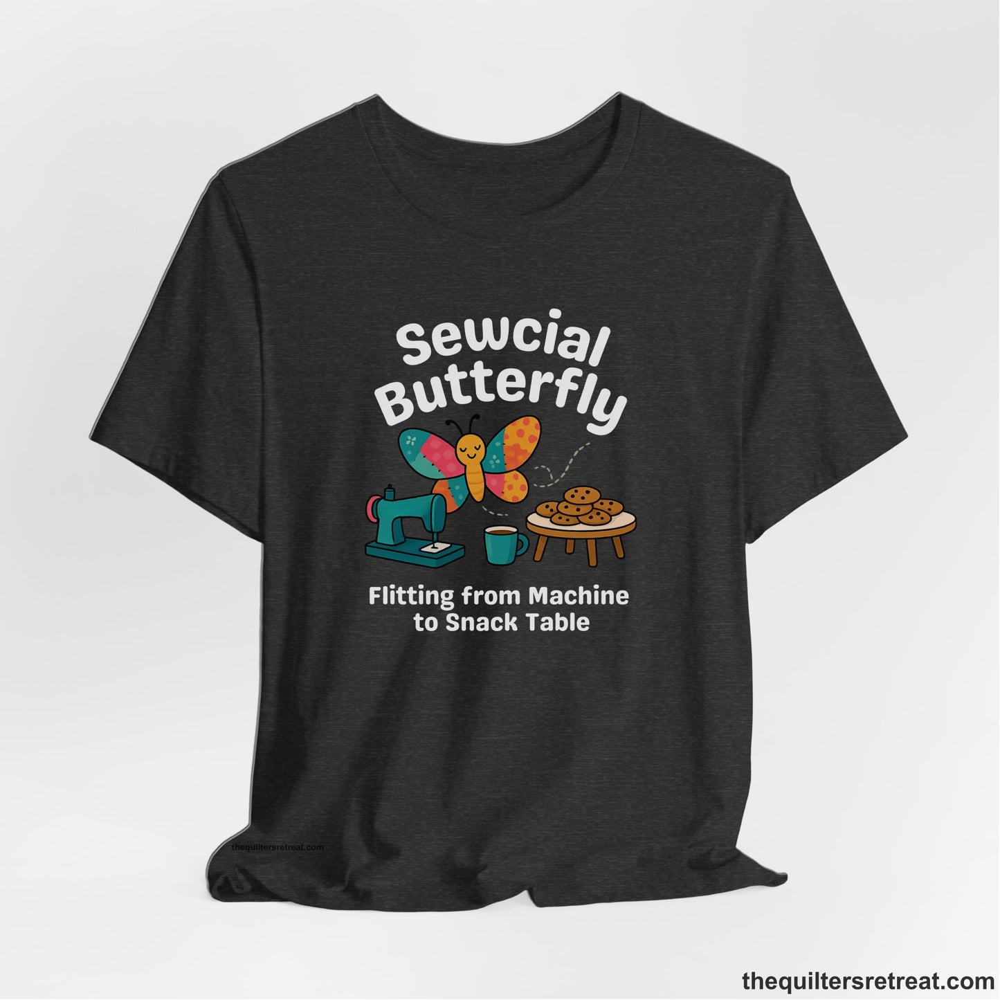 A Dark Grey Heather Short Sleeve T-Shirt with a playful butterfly near sewing machine with cookies and coffee doodle design