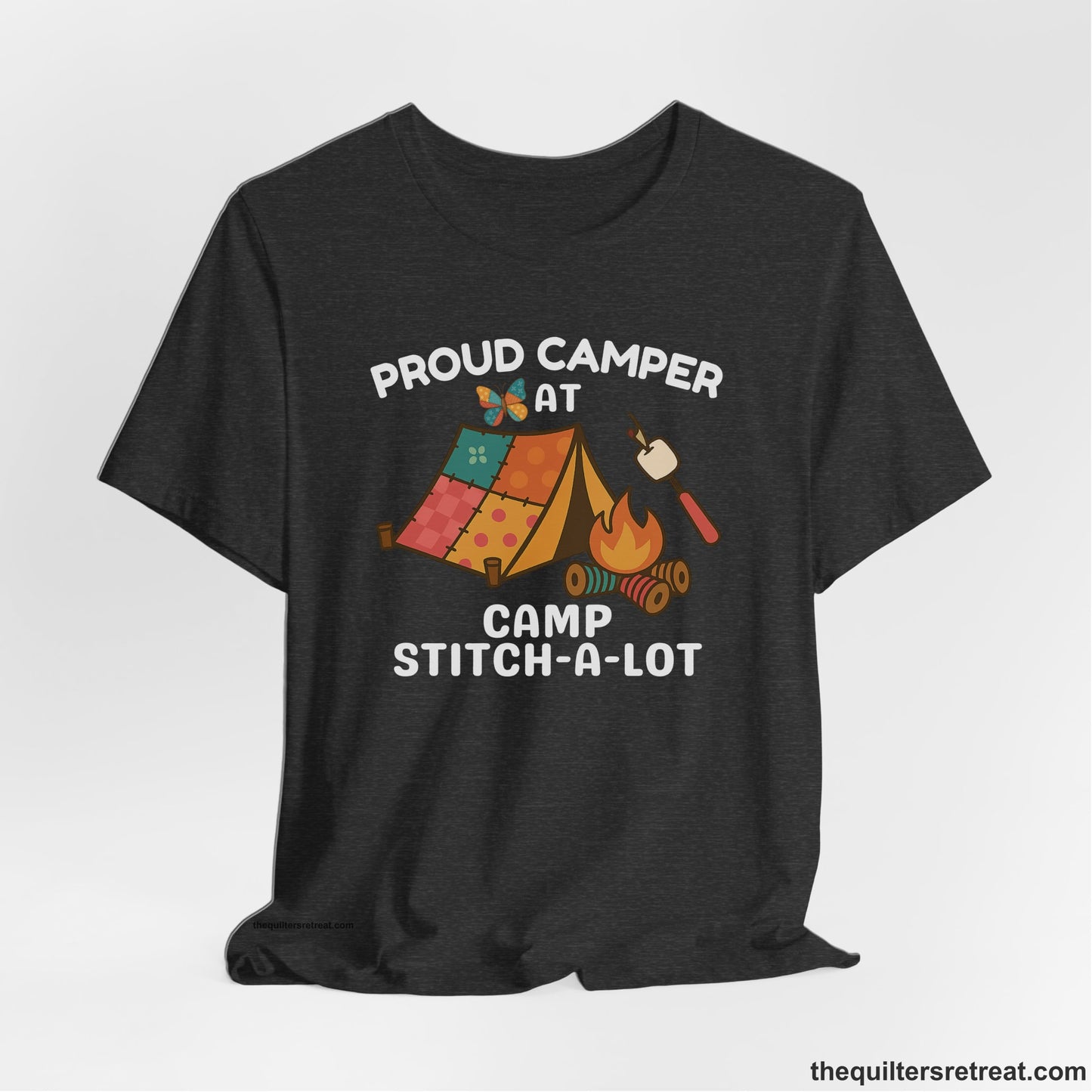 A Dark Grey Heather Short Sleeve T-Shirt with a camping scene with patchwork tent, campfire, and whimsical butterfly and marshmallow illustration
