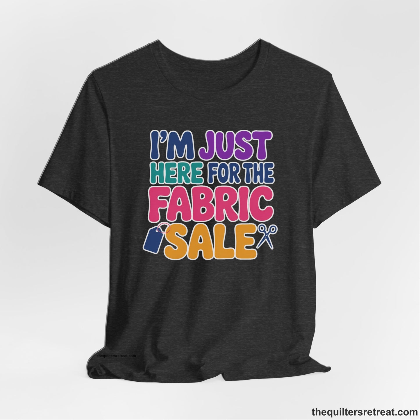 A Dark Grey Heather Short Sleeve T-Shirt with a playful "I'm Just Here for the Fabric Sale" text with colorful letters and sewing icons