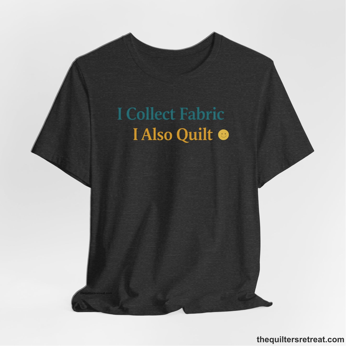 A Dark Grey Heather Short Sleeve T-Shirt with a Colorful text saying "I Collect Fabric I Also Quilt" with a playful, cheerful vibe.