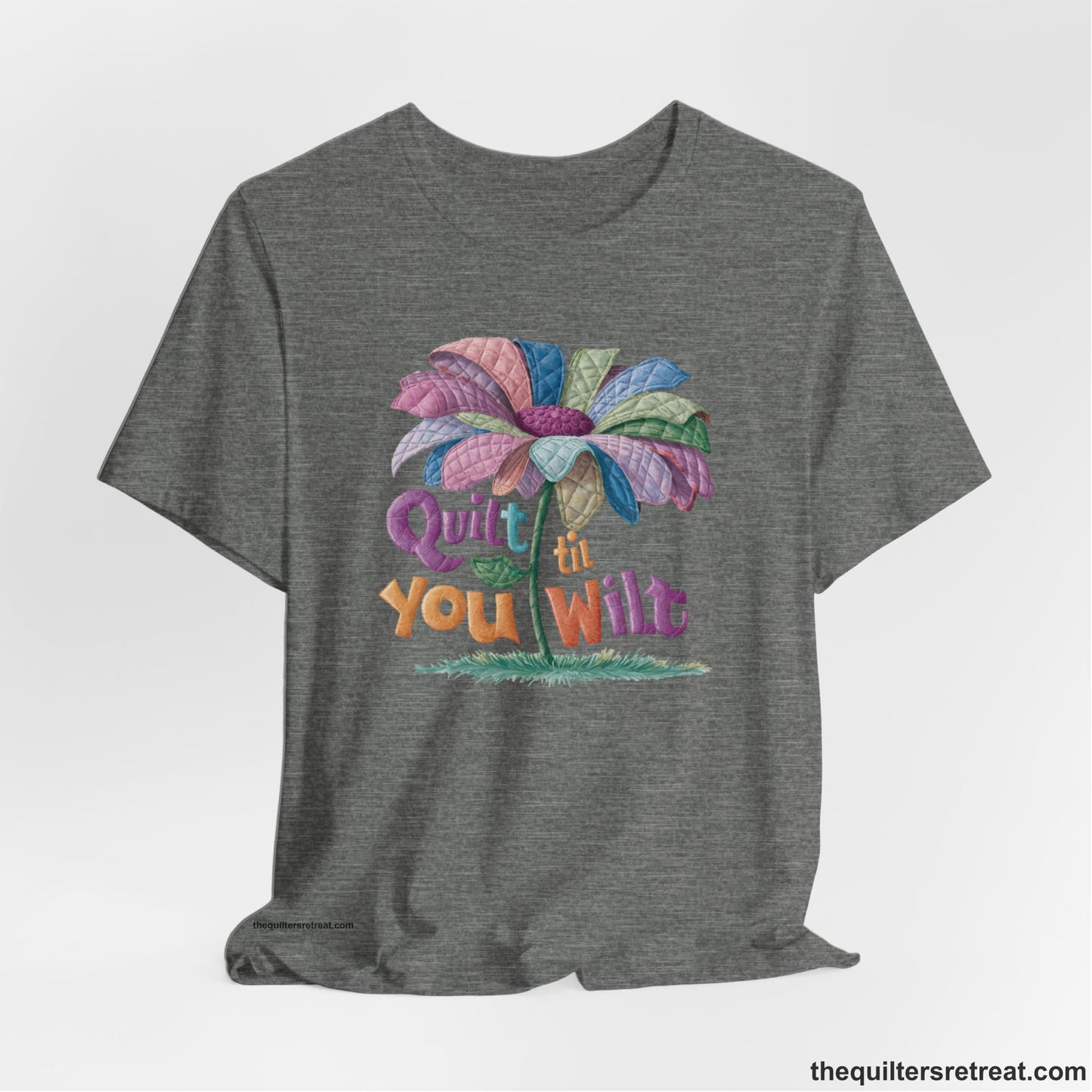 A Deep Heather Short Sleeve T-Shirt with a whimsical quilted flower with bold "Quilt til You Wilt" text