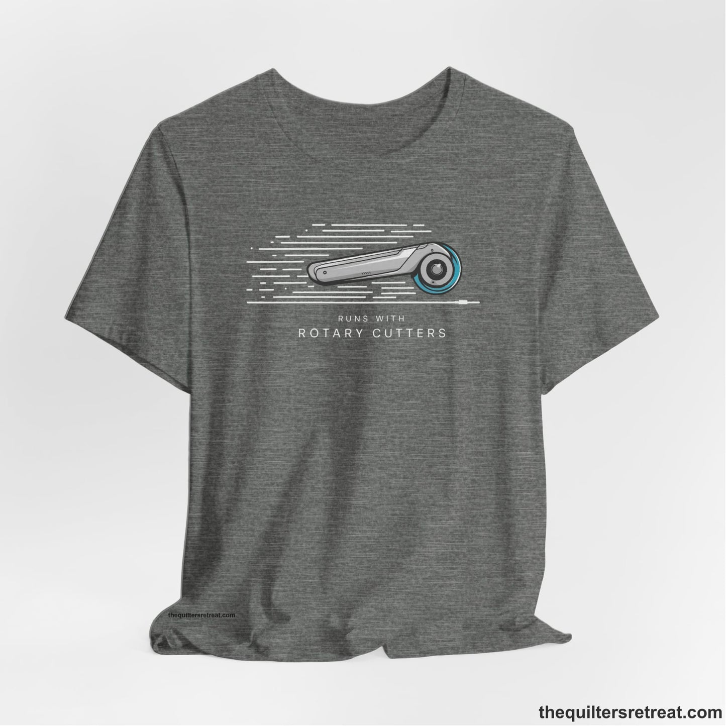 A Deep Heather Short Sleeve T-Shirt with a rotary cutter illustration with dynamic lines and bold "Runs with Rotary Cutters" text