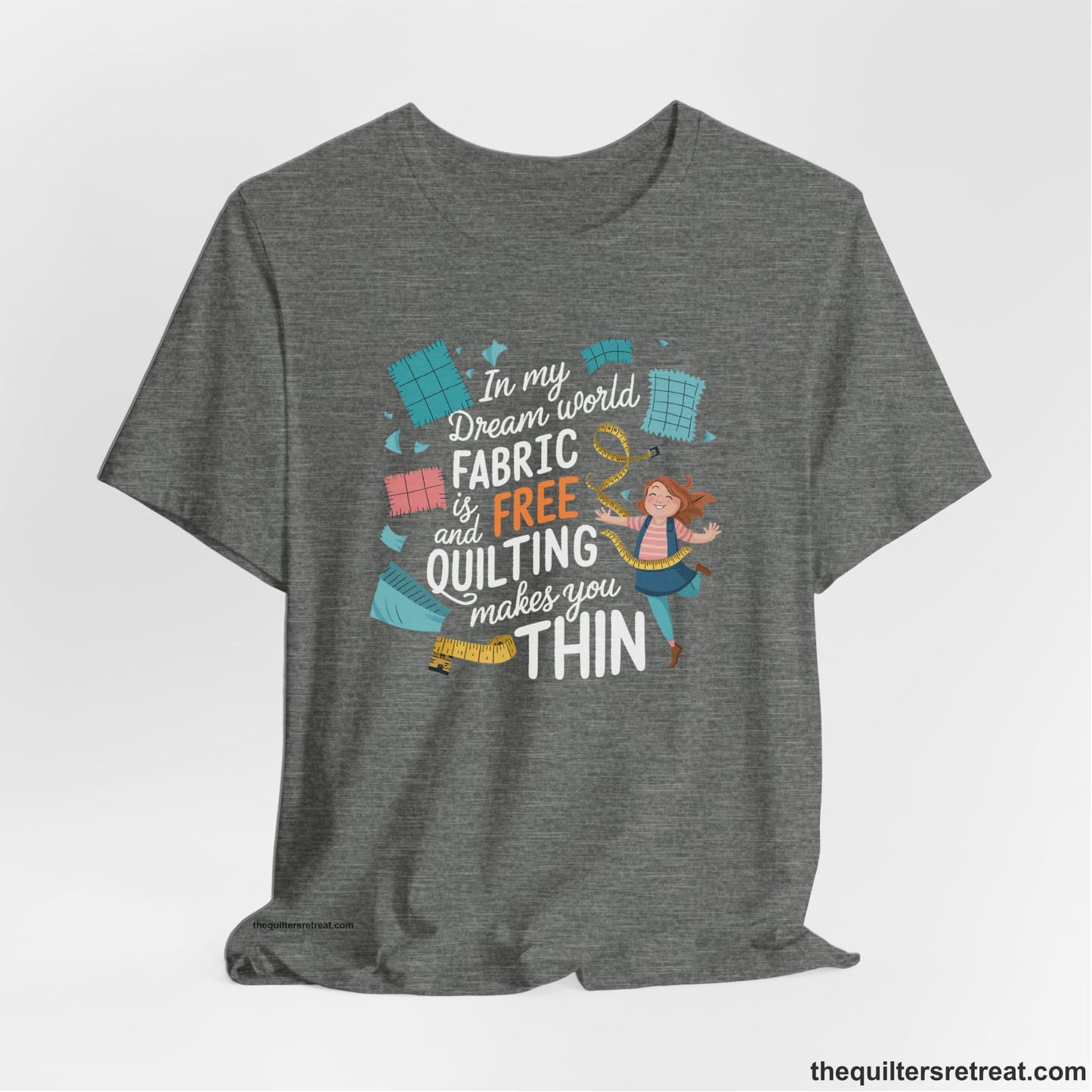 A Deep Heather Short Sleeve T-Shirt with a inspirational quilting text with playful seamstress and colorful fabric scraps in whimsical style